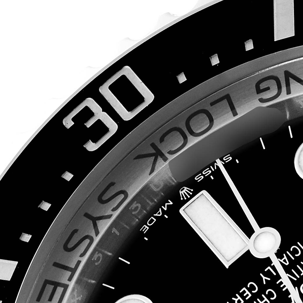 This close-up image of the Rolex Sea-Dweller 136660 Men's Stainless Steel Black Dial 136660 Men's Stainless Steel Black Dial watch shows the bezel, minute hand, and part of the dial, emphasizing the "SWISS MADE" text and logo.