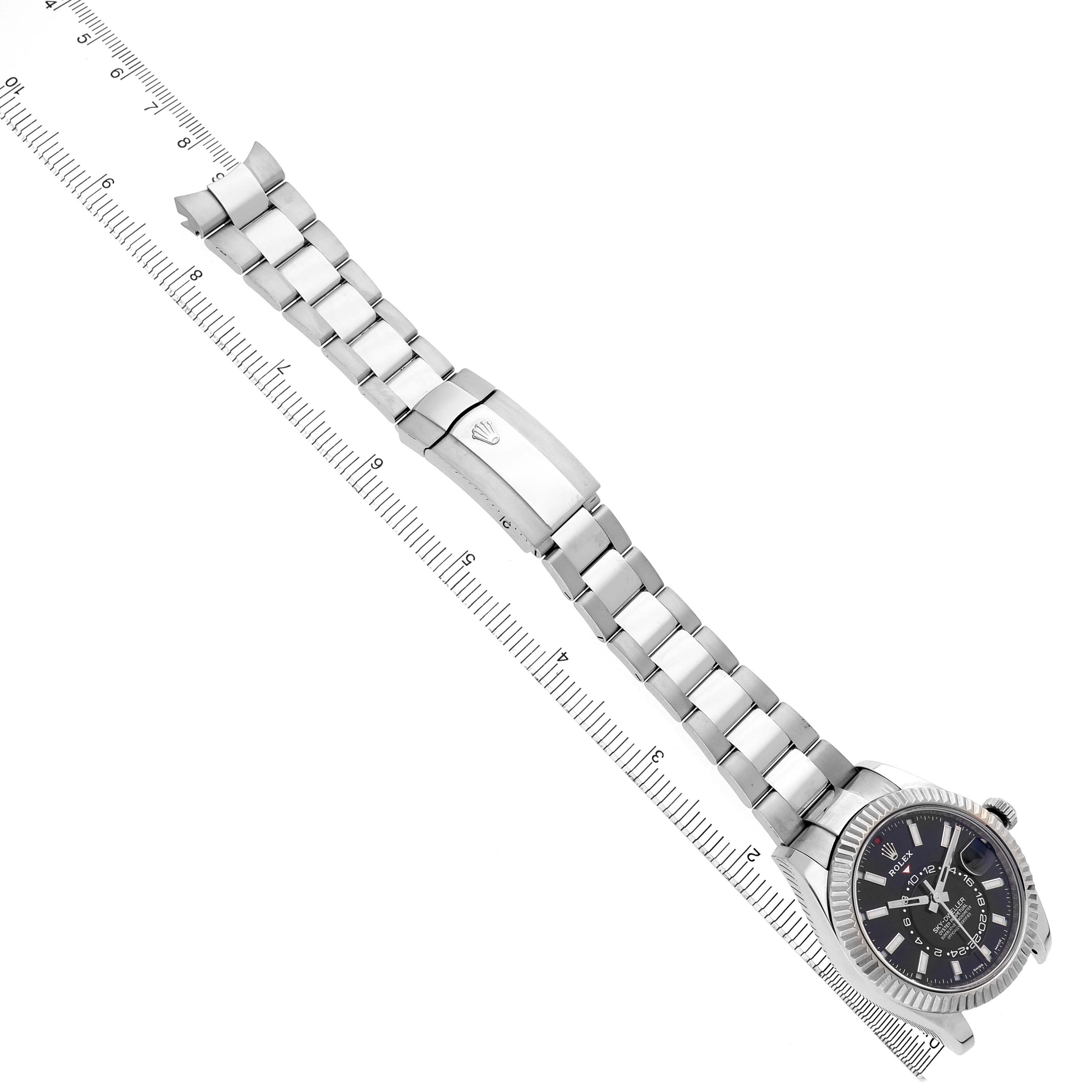 The Rolex Sky-Dweller 326934 Men's Stainless Steel Black Dial watch is shown at a diagonal angle with its bracelet fully extended and clasp visible.