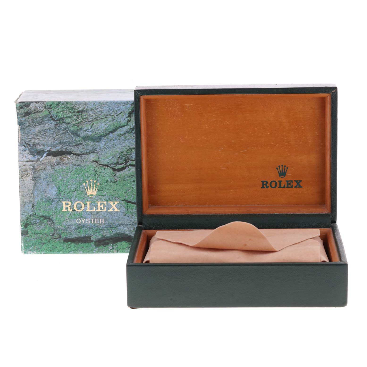 The image shows the packaging box for a Rolex Submariner 14060 Men
s Stainless Steel Black Dial 14060 Men
s Stainless Steel Black Dial watch, open to reveal its interior.