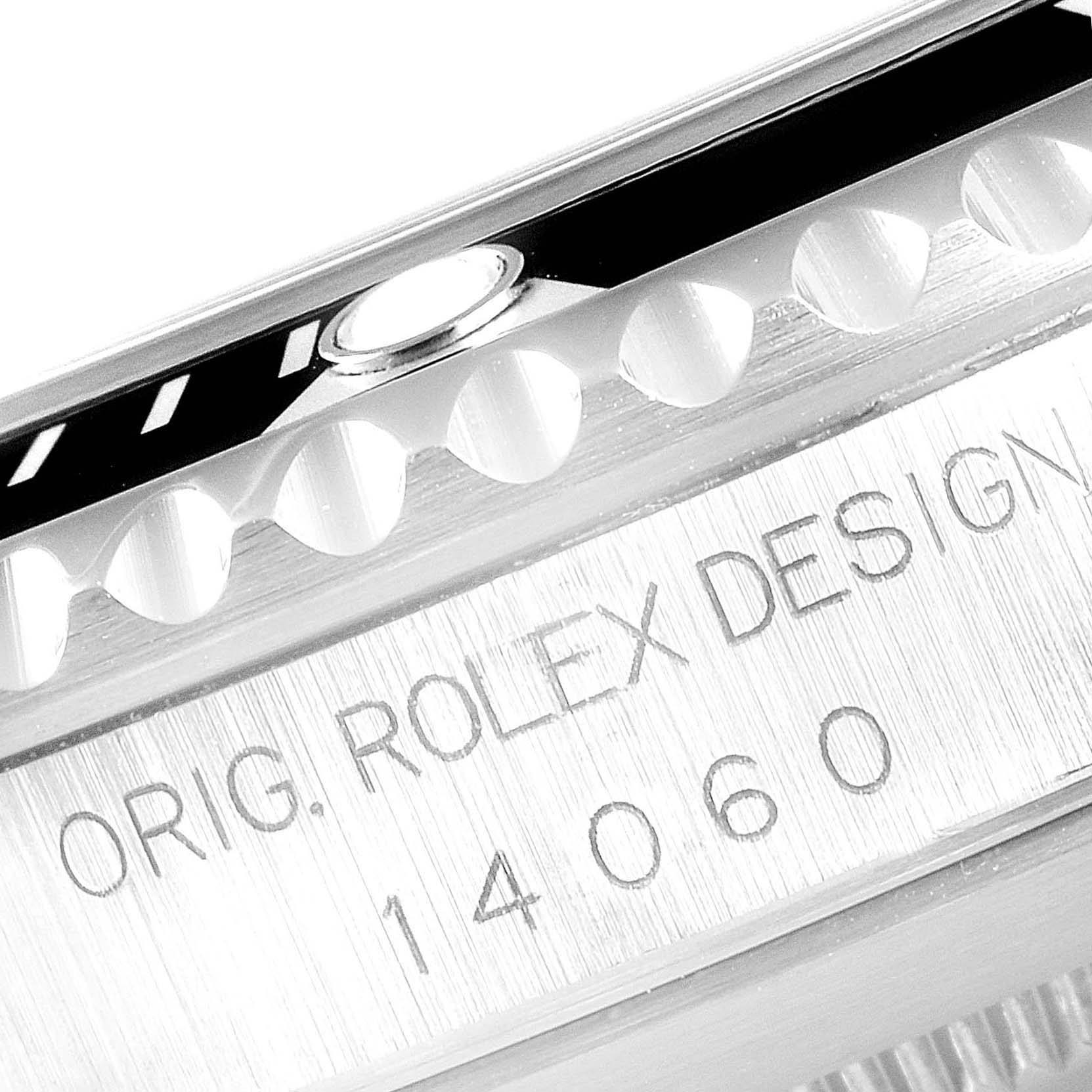 The image shows a close-up of the edge of the bezel and the engraved side of a Rolex Submariner 14060 Men
s Stainless Steel Black Dial 14060 Men
s Stainless Steel Black Dial watch, model 14060.