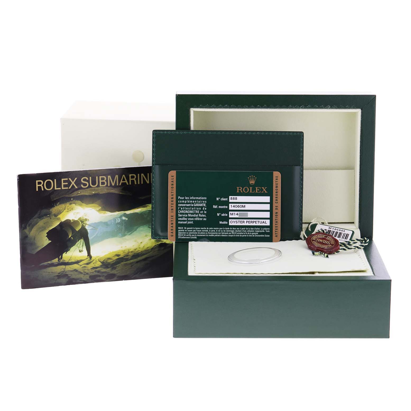 This image shows accessories for a Rolex Submariner 14060 Men
s Stainless Steel Black Dial 14060 Men
s Stainless Steel Black Dial, including the watch box, papers, warranty card, and tags.