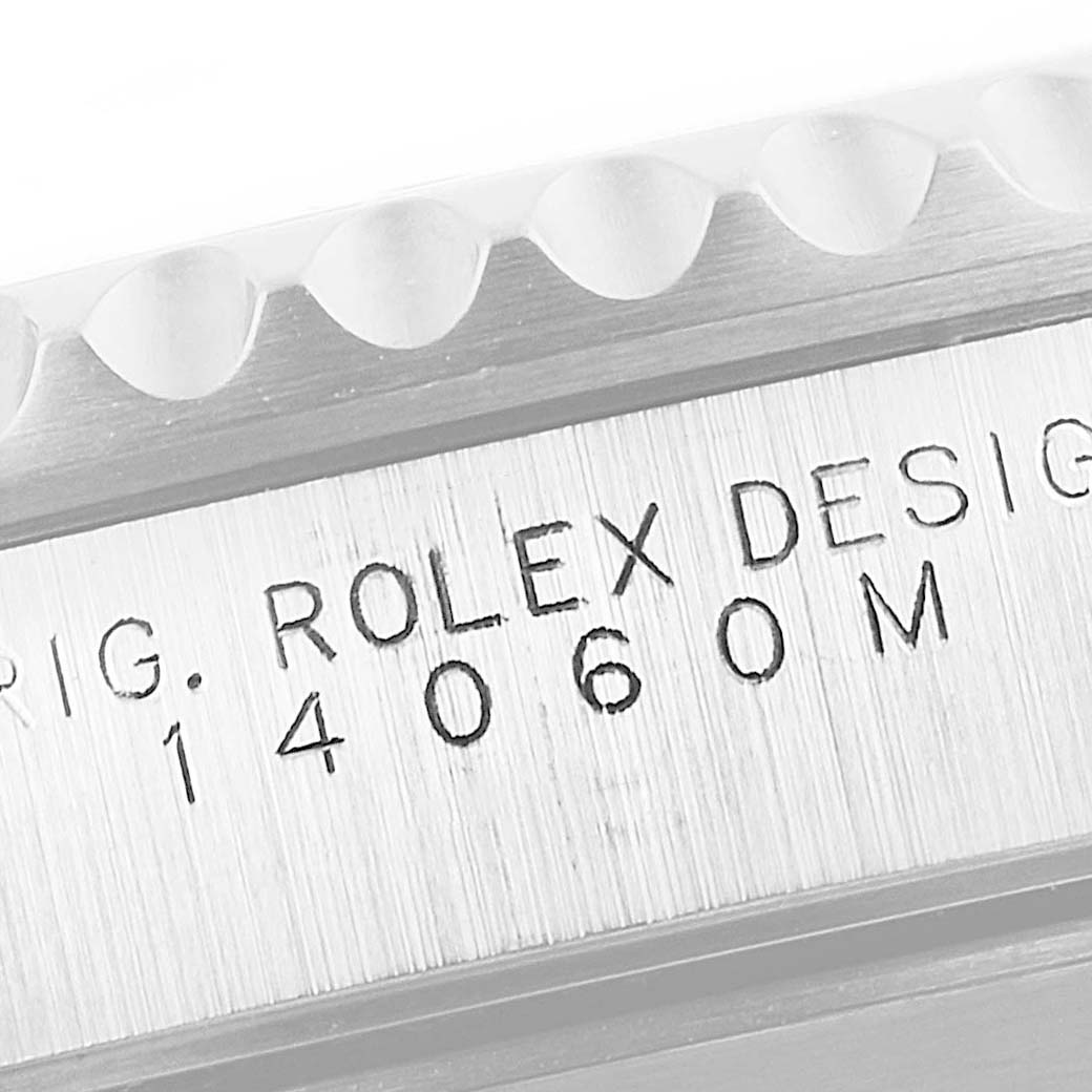 This close-up shows the engraved model number and "ROLEX DESIGN" text on the side of a Rolex Submariner 14060 Men
s Stainless Steel Black Dial 14060 Men
s Stainless Steel Black Dial watch case.