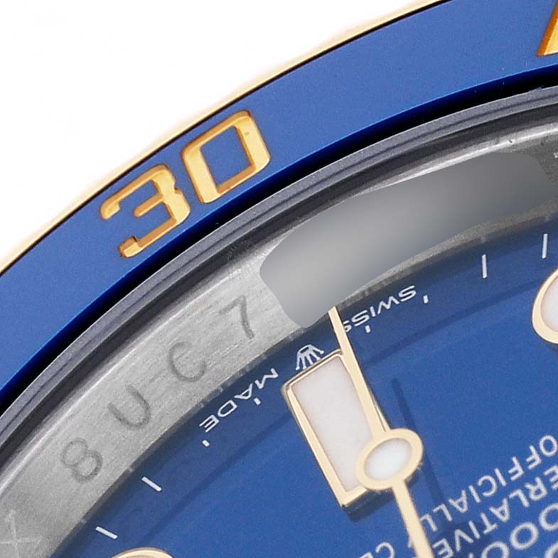 The image shows a close-up of the Rolex Submariner 126613 Men's Steel and Gold (two tone) Blue Dial's blue bezel, with the minute markers and part of the dial visible.