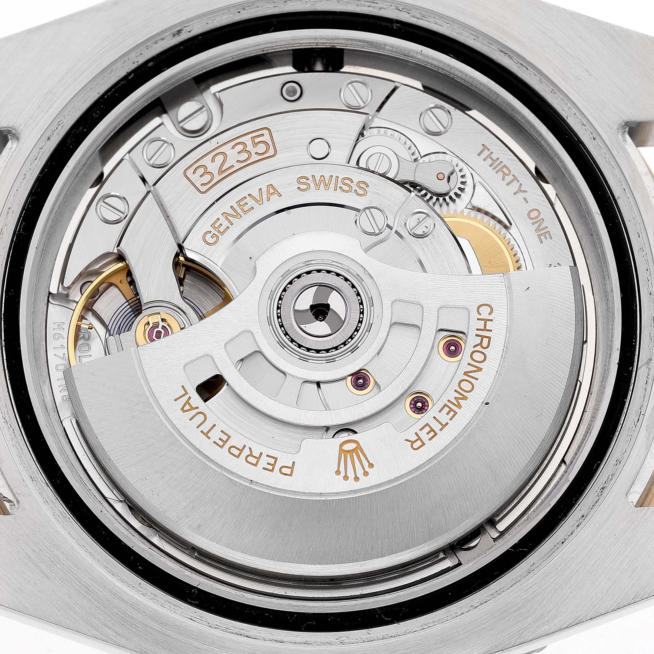 The image shows a close-up of the Rolex Submariner 126613 Men's Steel and Gold (two tone) Blue Dial's movement, focusing on its intricate mechanical components from a top angle.