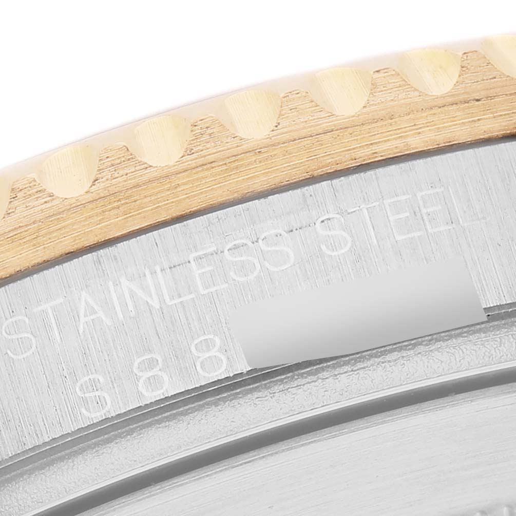 The image shows a close-up of the bezel and edge of the case for a Rolex Submariner 16613 Men's Steel and Gold (two tone) Champagne Dial, highlighting the metal finish and engraving.