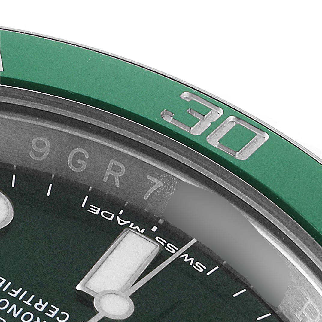 The image shows a close-up of the bezel and part of the dial of a Rolex Submariner 116610LV Men
s Stainless Steel Green Dial 116610LV Men
s Stainless Steel Green Dial watch, focusing on the 30-minute marker.