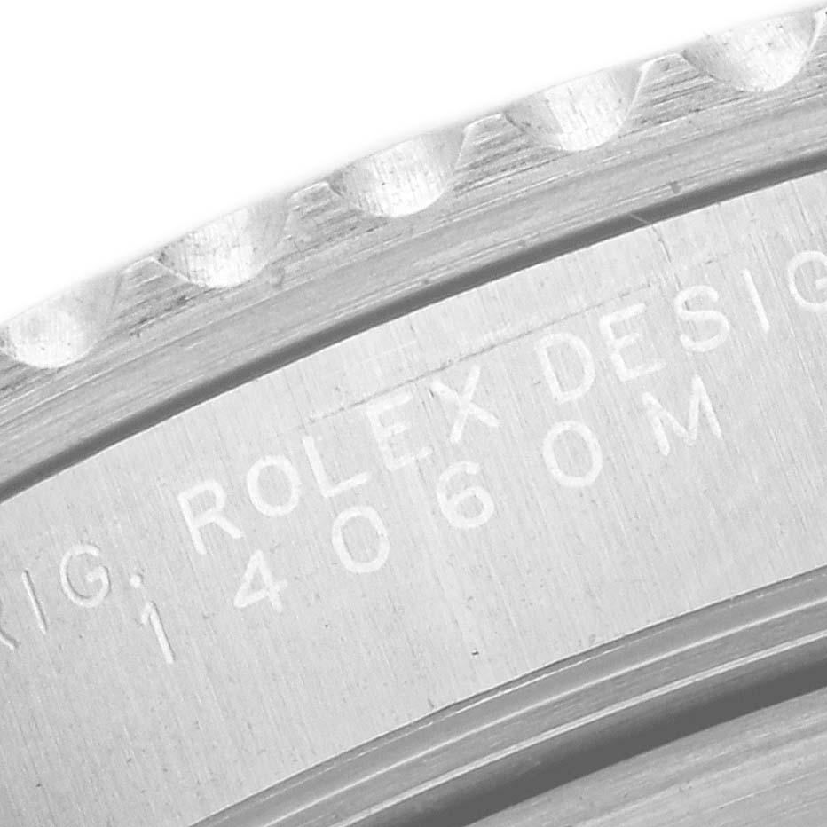 This image shows a close-up view of the engraved side of the Rolex Submariner 14060 Men
s Stainless Steel Black Dial 14060 Men
s Stainless Steel Black Dial model.