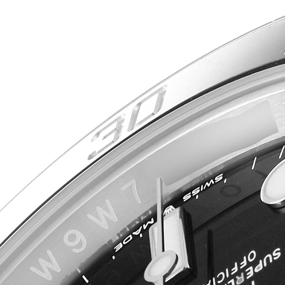This close-up image of the Rolex Submariner 124060 Men
s Stainless Steel Black Dial 124060 Men
s Stainless Steel Black Dial watch shows part of the dial and bezel at an angle.