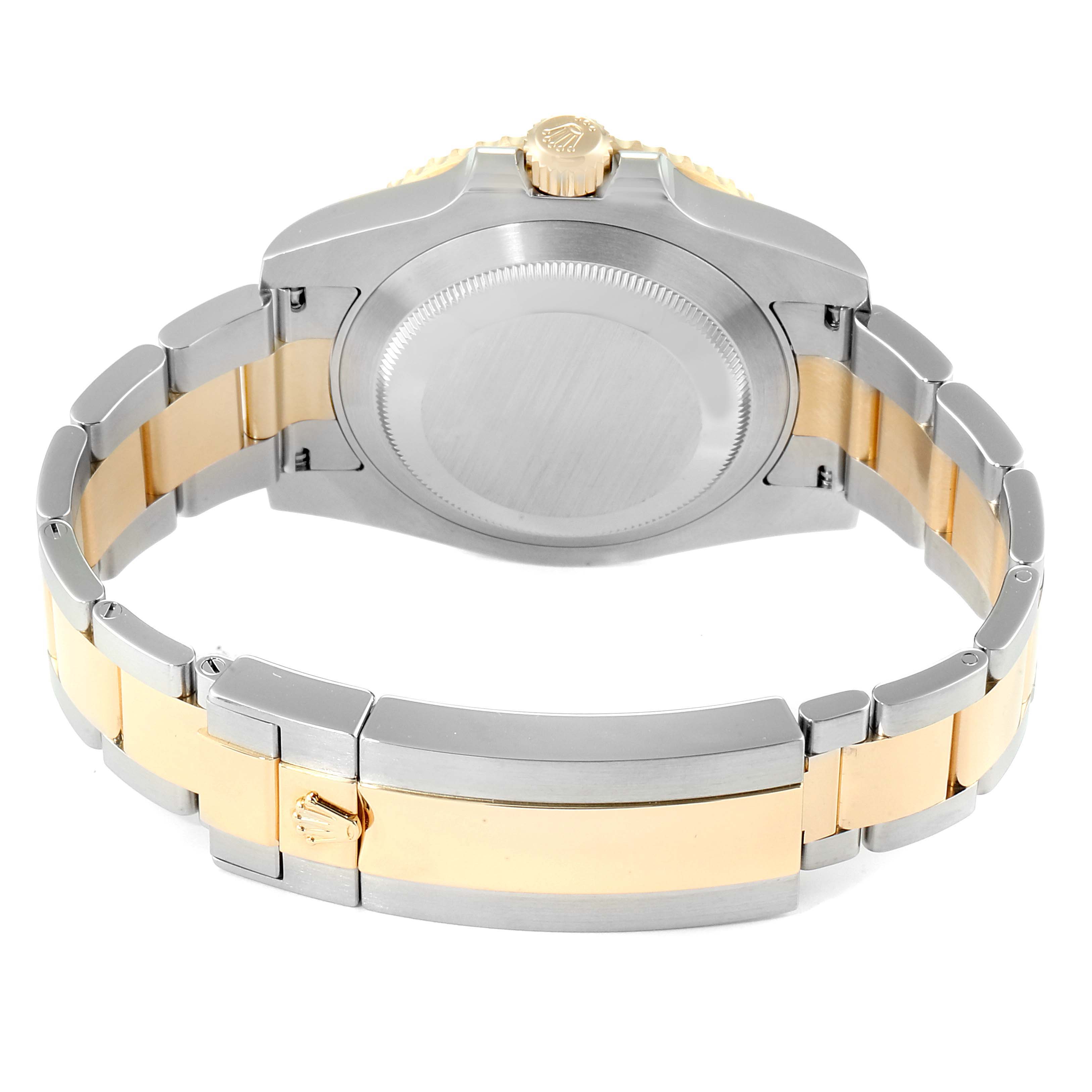 The image shows the back view of a Rolex Submariner 116613 Men
s Steel and Gold (two tone) Black Dial 116613 Men
s Steel and Gold (two tone) Black Dial watch, highlighting its case back, crown, and two-tone metal bracelet.