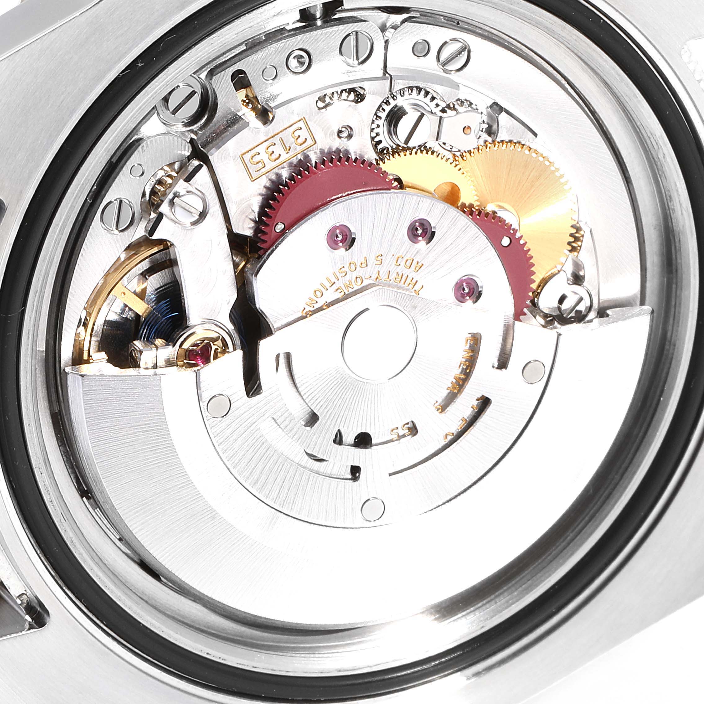 The image shows the intricate movement mechanism and internal parts of a Rolex Submariner 116613 Men
s Steel and Gold (two tone) Black Dial 116613 Men
s Steel and Gold (two tone) Black Dial watch from a close-up angle.