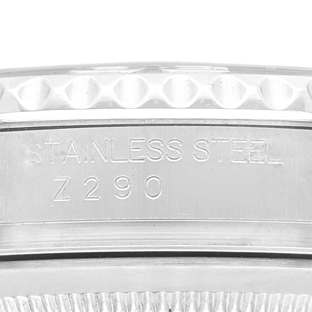 This close-up image of a Rolex Yacht-Master 16622 Men's Stainless Steel Silver Dial 16622 Men's Stainless Steel Silver Dial watch shows the side of the stainless steel case with engravings.