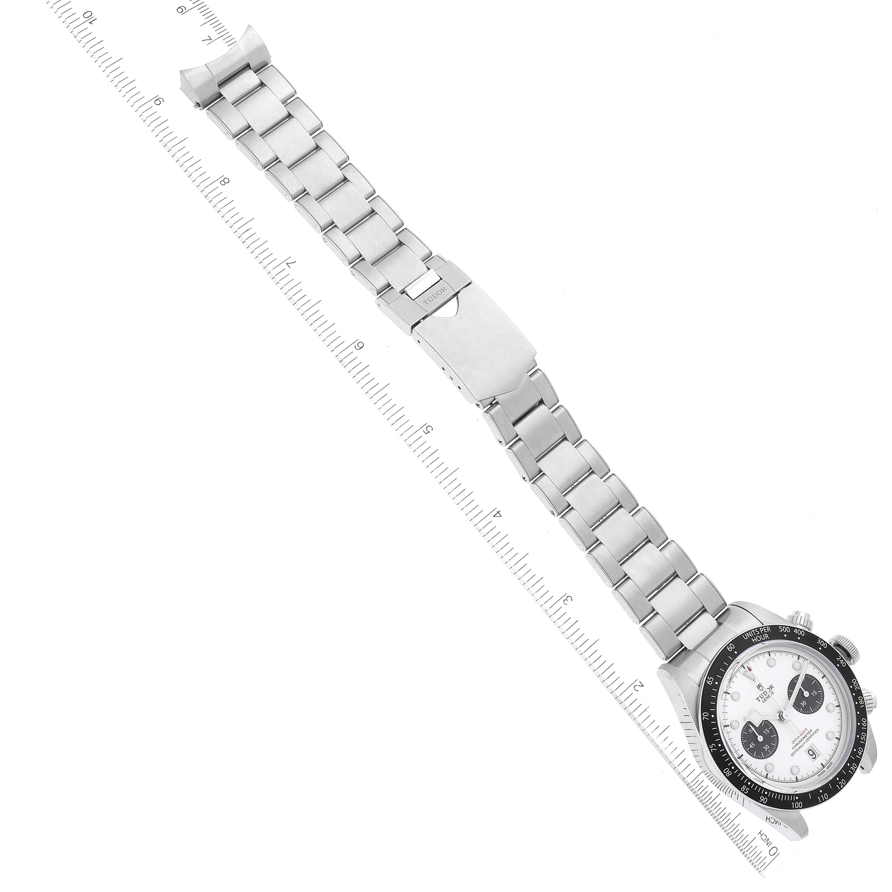 The Tudor Heritage Chrono M79360N-0002 Men's Stainless Steel Silver Dial M79360N-0002 Men's Stainless Steel Silver Dial watch is shown at an angle, displaying the face, bezel, bracelet, and clasp along with a ruler for scale.