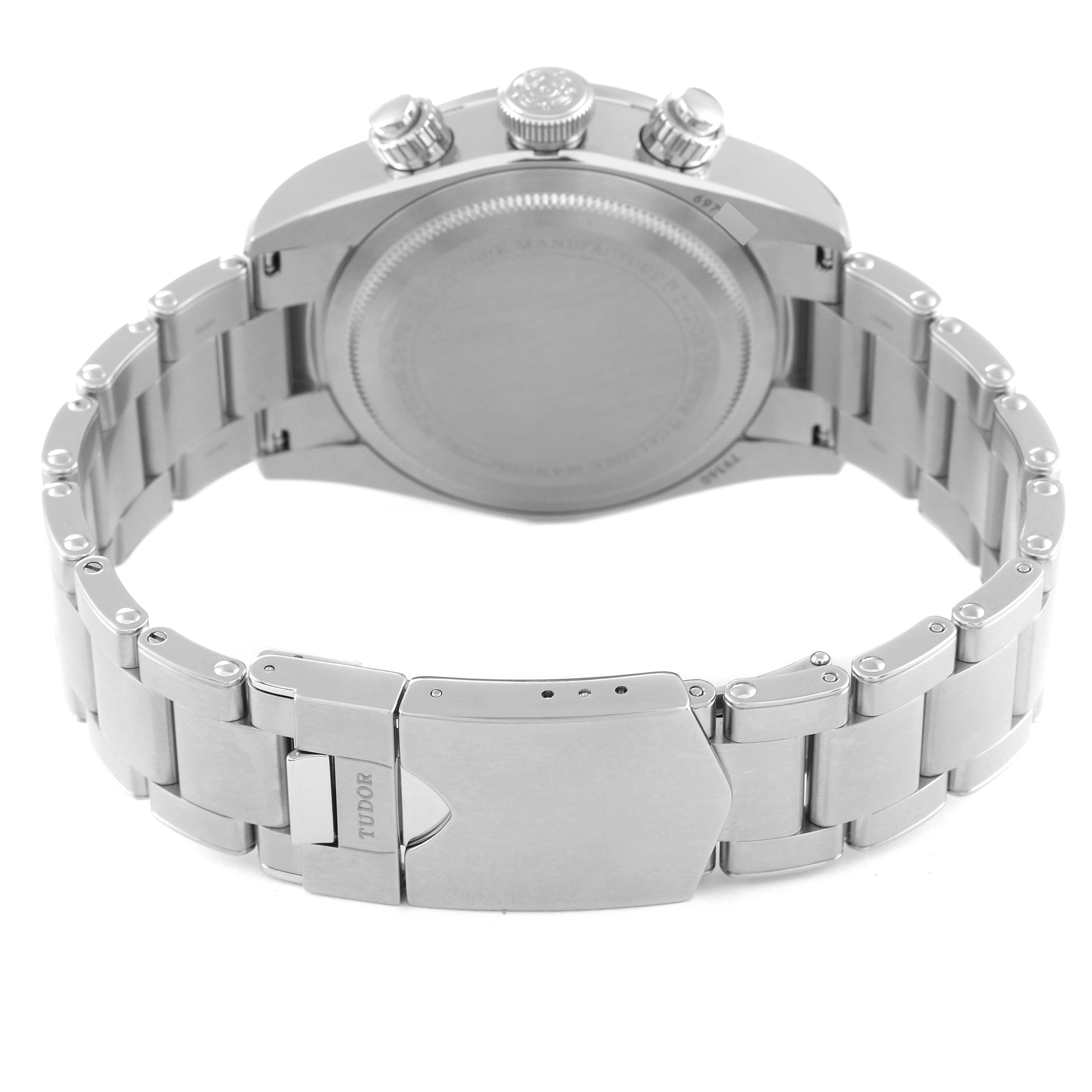 This image shows the backside and bracelet clasp of a Tudor Heritage Chrono M79360N-0002 Men's Stainless Steel Silver Dial M79360N-0002 Men's Stainless Steel Silver Dial watch, including the screw-down case back and the "Tudor" engraved clasp.