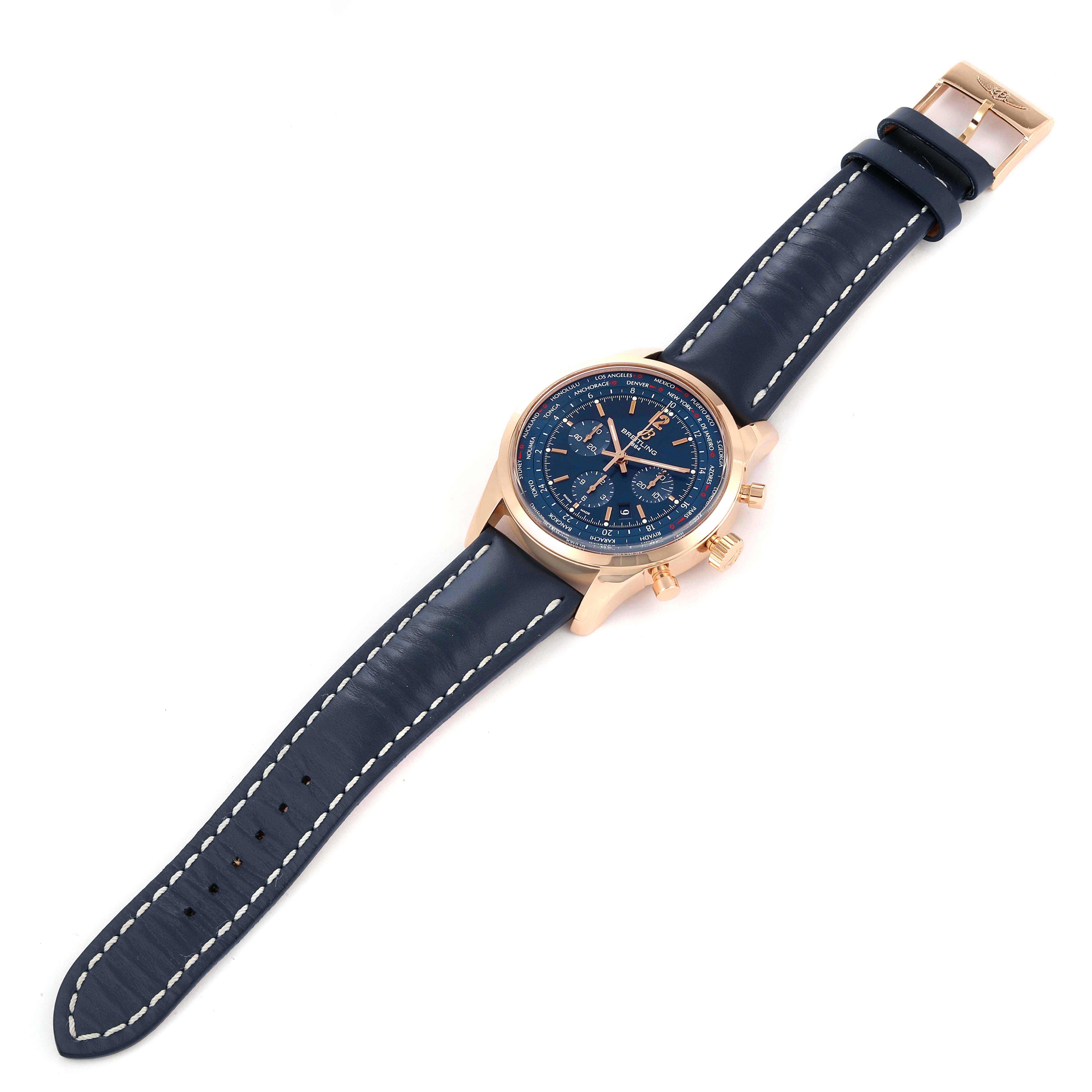 The Breitling Transocean RB0510 Men's Rose Gold Blue Dial RB0510 Men's Rose Gold Blue Dial watch is shown from an elevated angle, displaying the entire face, case, and leather strap.