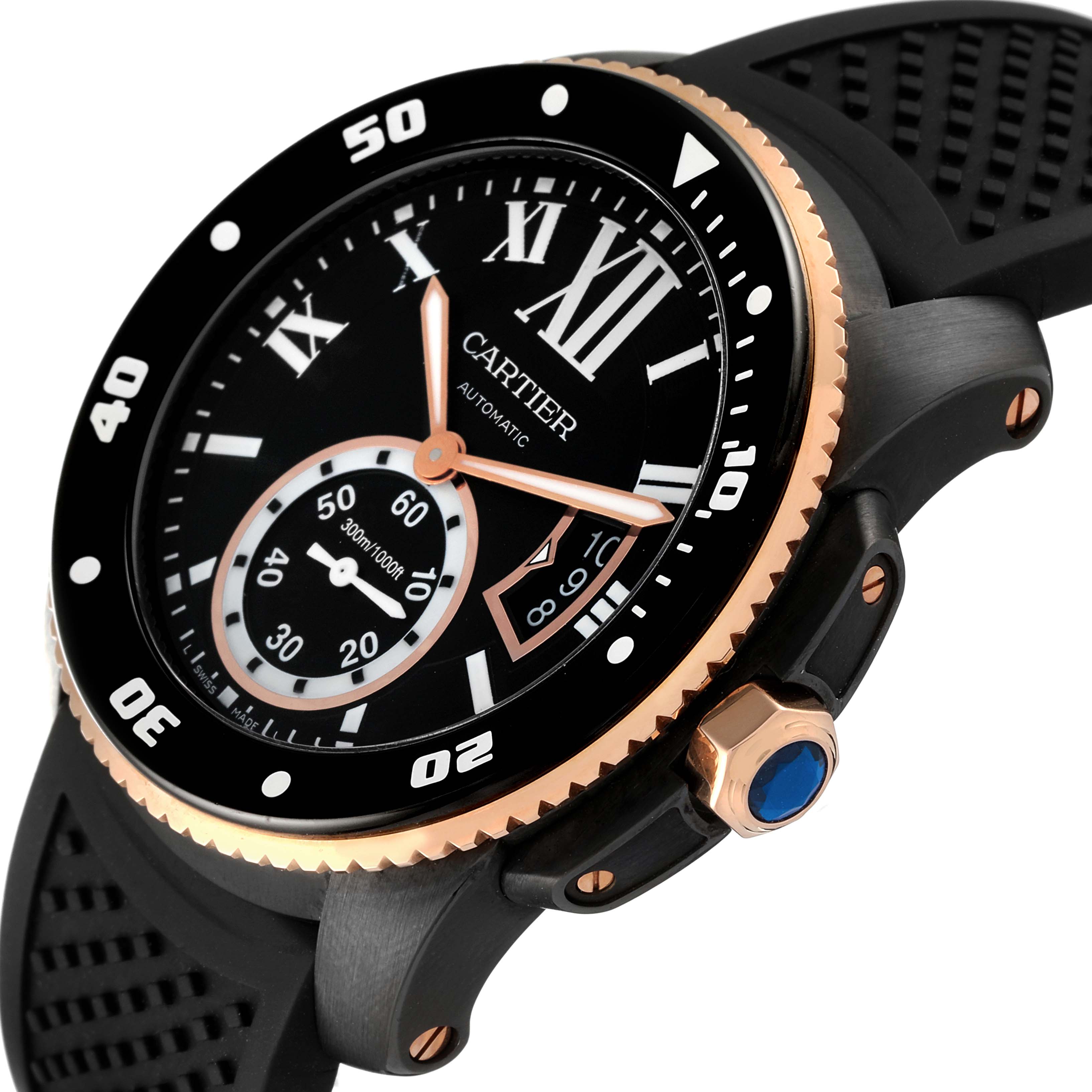 The image shows a close-up of the face and bezel of a Calibre de Cartier watch by Cartier, highlighting its black dial and rubber strap.