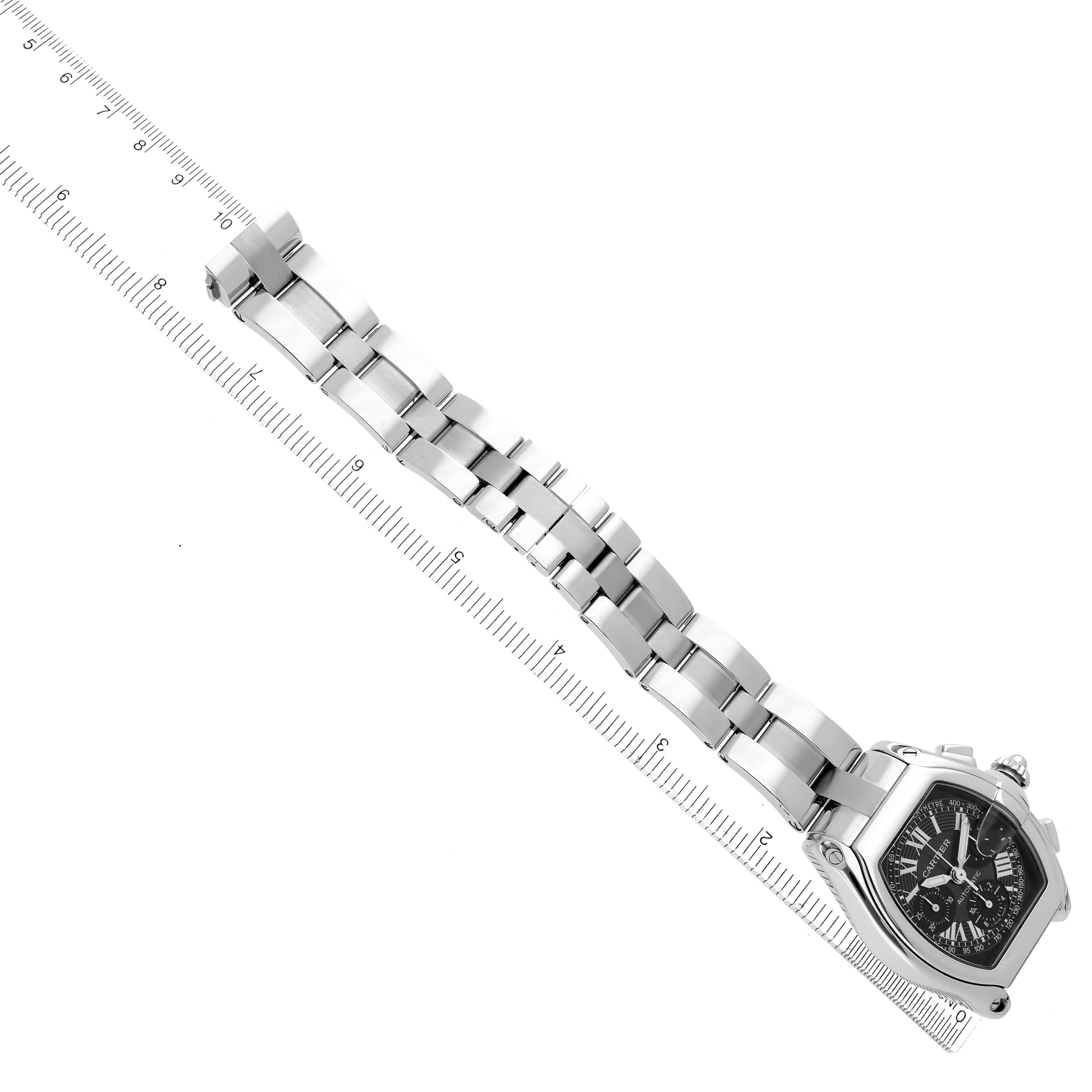 The Cartier Roadster W62007X6 Men's Stainless Steel Black Dial W62007X6 Men's Stainless Steel Black Dial watch is shown at an oblique angle, displaying the bracelet and face alongside a ruler for scale.