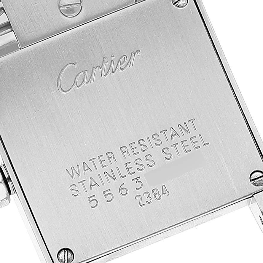 This image shows the back case of the Cartier Tank Francaise W51028Q3 Women's Stainless Steel Mother of Pearl Dial W51028Q3 Women's Stainless Steel Mother of Pearl Dial watch with engraved branding, material, and serial numbers.
