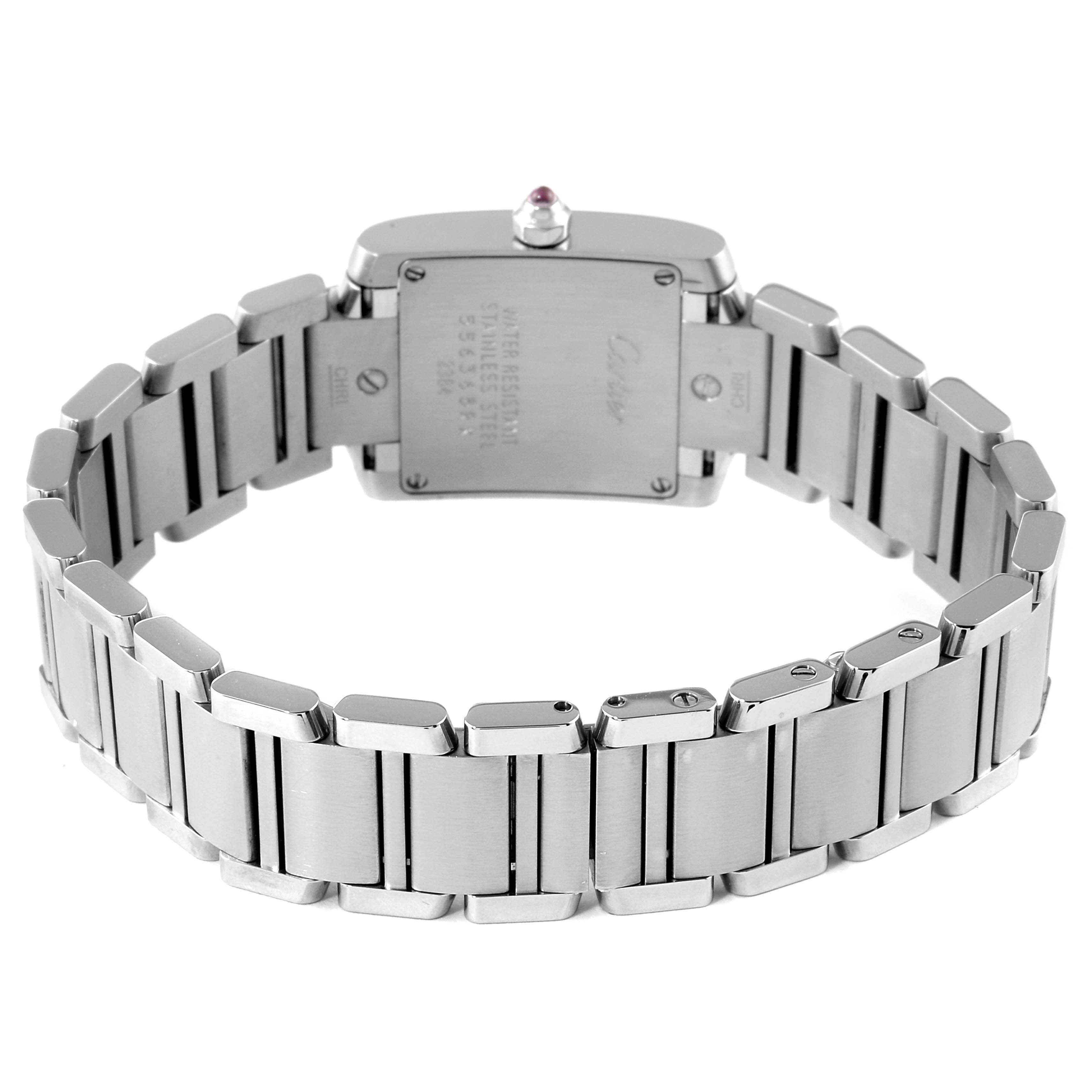 The image shows the back angle of a Cartier Tank Française watch with a visible stainless steel bracelet and caseback.