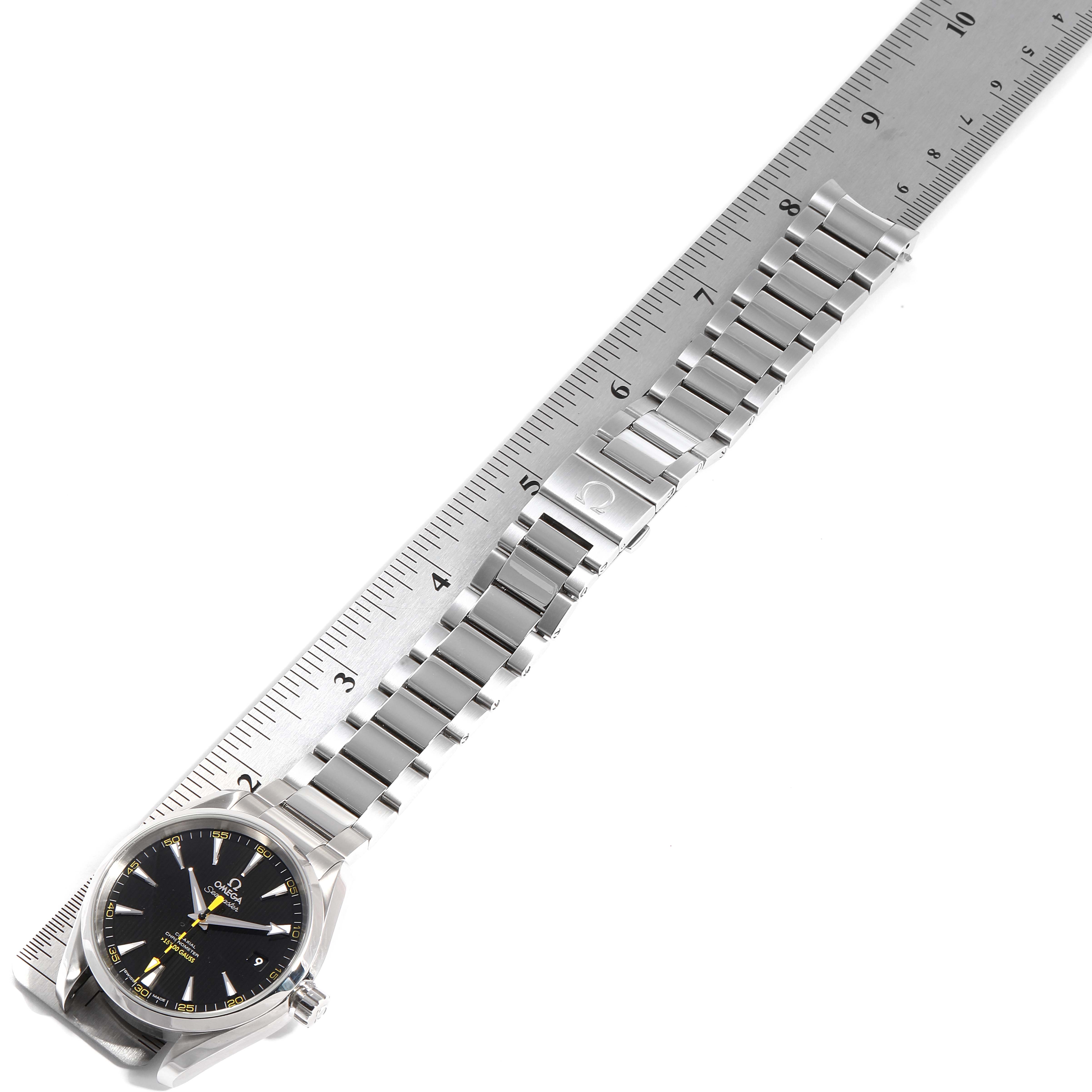 The image shows an Omega Aqua Terra 231.10.42.21.01.002 Men's Stainless Steel Black Dial 231.10.42.21.01.002 Men's Stainless Steel Black Dial watch laid flat at an angle, with a ruler measuring its metal bracelet band.