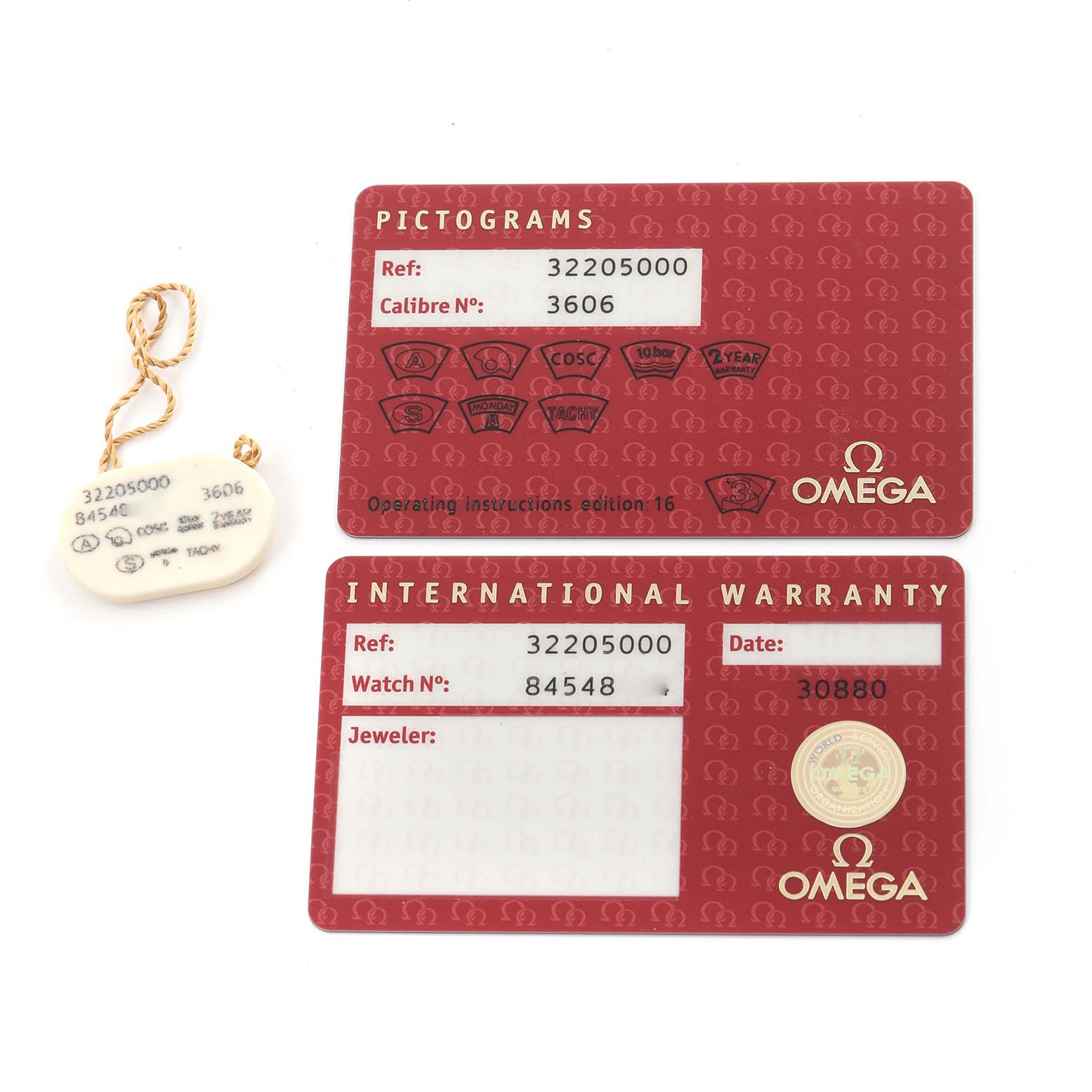 The image shows pictogram and international warranty cards and a tag for the Omega Speedmaster 3220.50.00 Men's Stainless Steel Black Dial 3220.50.00 Men's Stainless Steel Black Dial model.