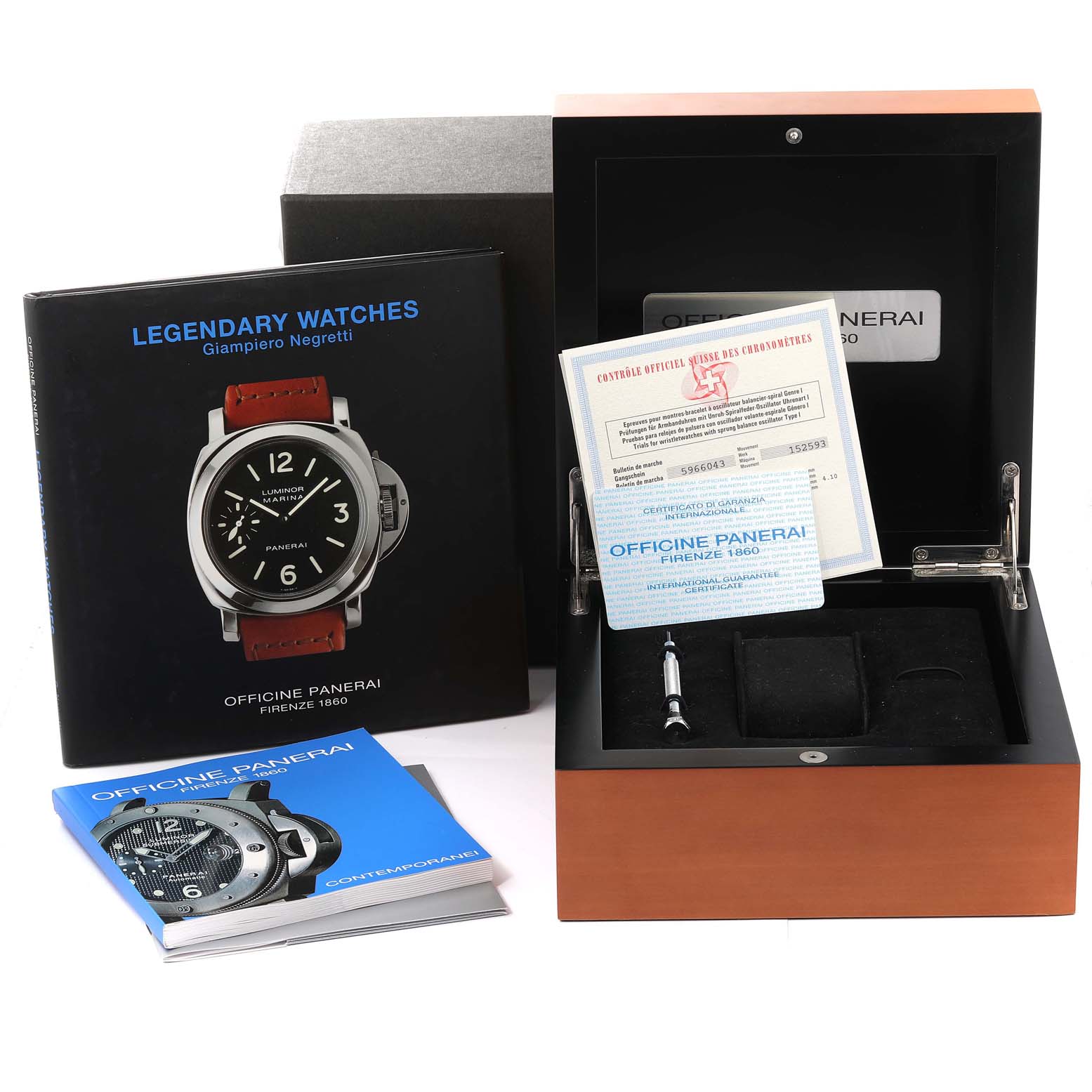 The image shows packaging, documentation, and tools for a Panerai Luminor PAM00023 Men
s Stainless Steel Black Dial PAM00023 Men
s Stainless Steel Black Dial watch, including a wooden box and manuals.
