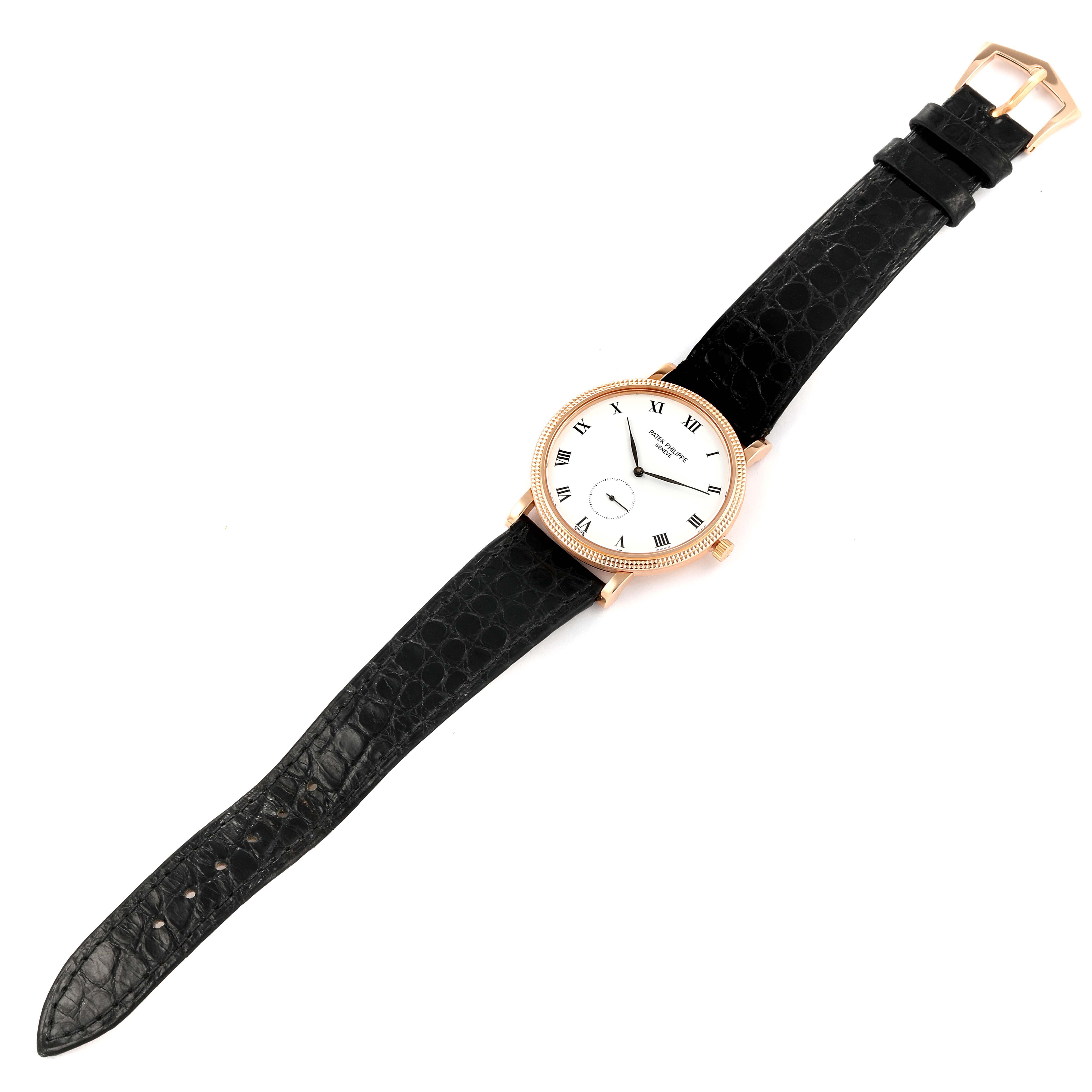 The image shows a Patek Philippe Calatrava 3919R Men's Rose Gold White Dial 3919R Men's Rose Gold White Dial model watch from a top-down angle, displaying the face, strap, and buckle.