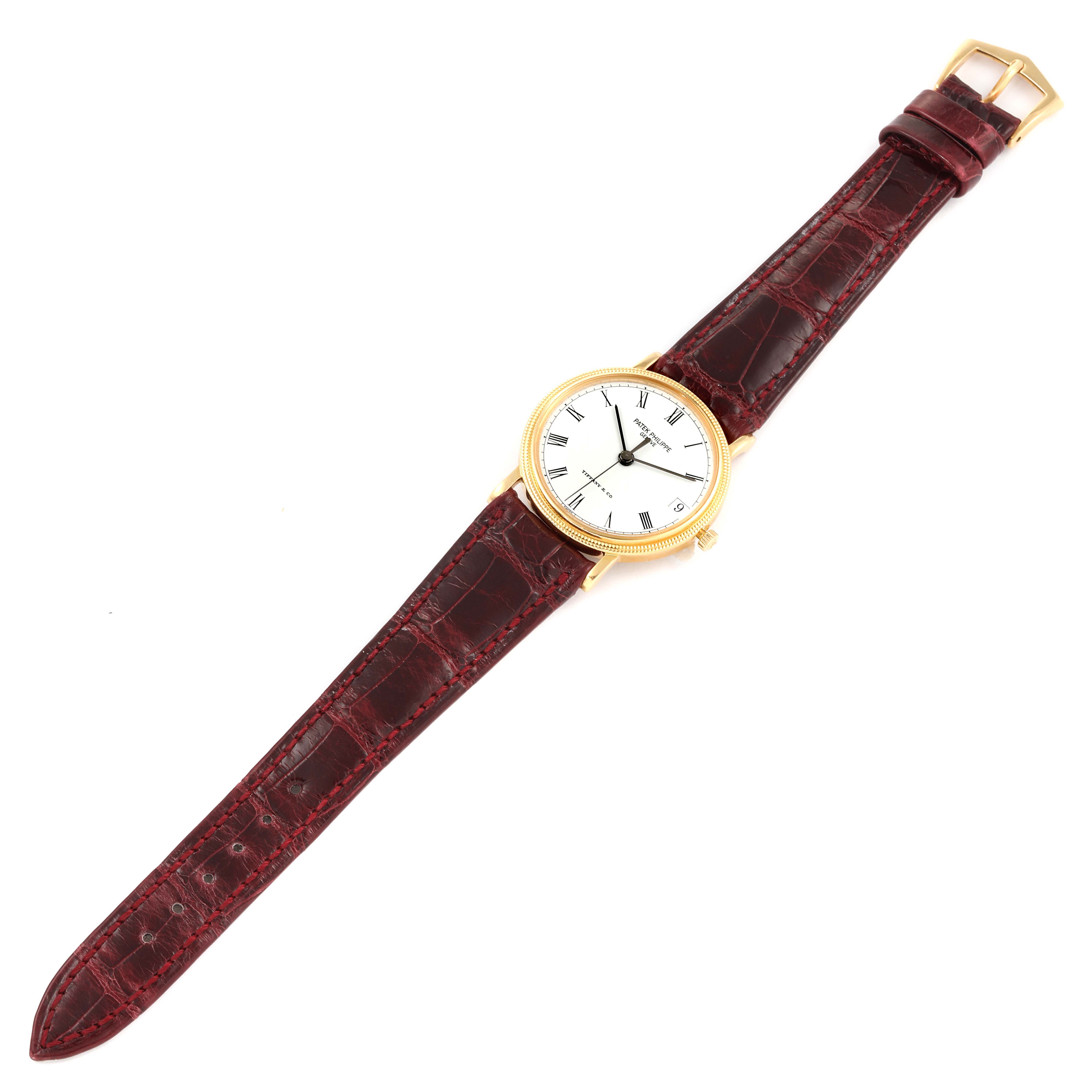 The Patek Philippe Calatrava 3802G Men's Yellow Gold White Dial 3802G Men's Yellow Gold White Dial watch is shown from an overhead angle, displaying the full face, strap, and buckle.