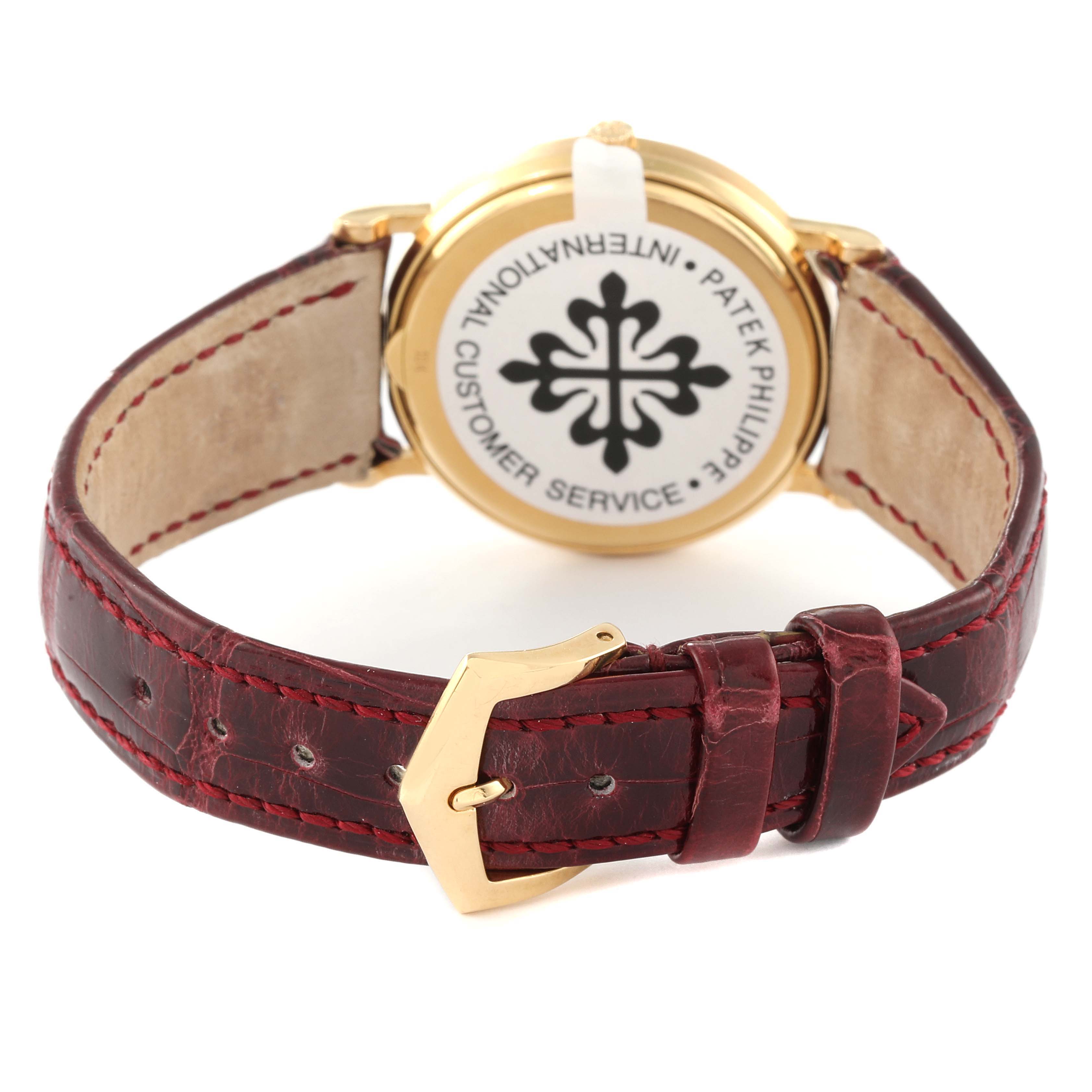 This image shows the back view of a Patek Philippe Calatrava 3802G Men's Yellow Gold White Dial 3802G Men's Yellow Gold White Dial watch, highlighting the back case and red leather strap with a gold buckle.