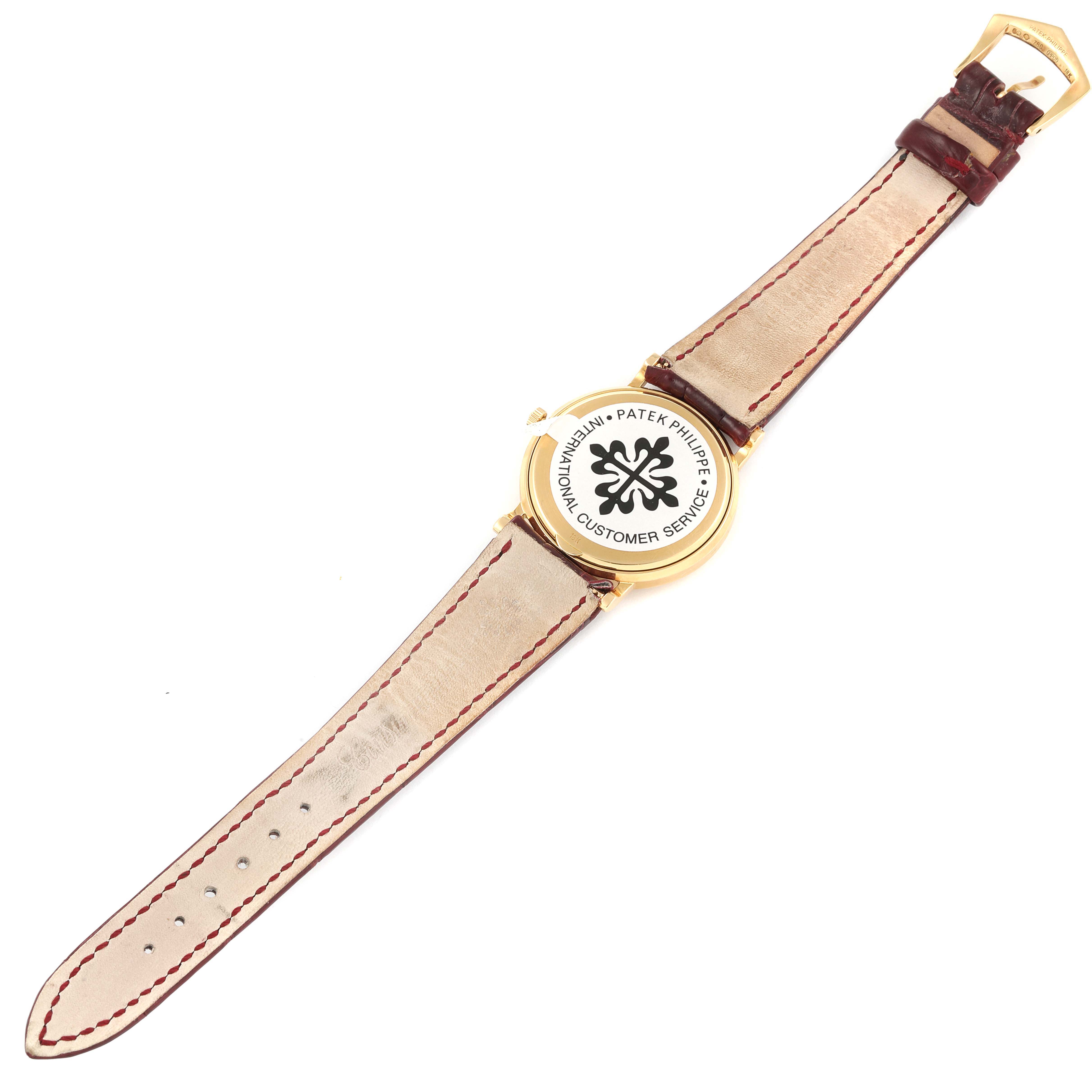 The image shows a Patek Philippe Calatrava 3802G Men's Yellow Gold White Dial 3802G Men's Yellow Gold White Dial watch from the back, displaying the case back and leather strap.