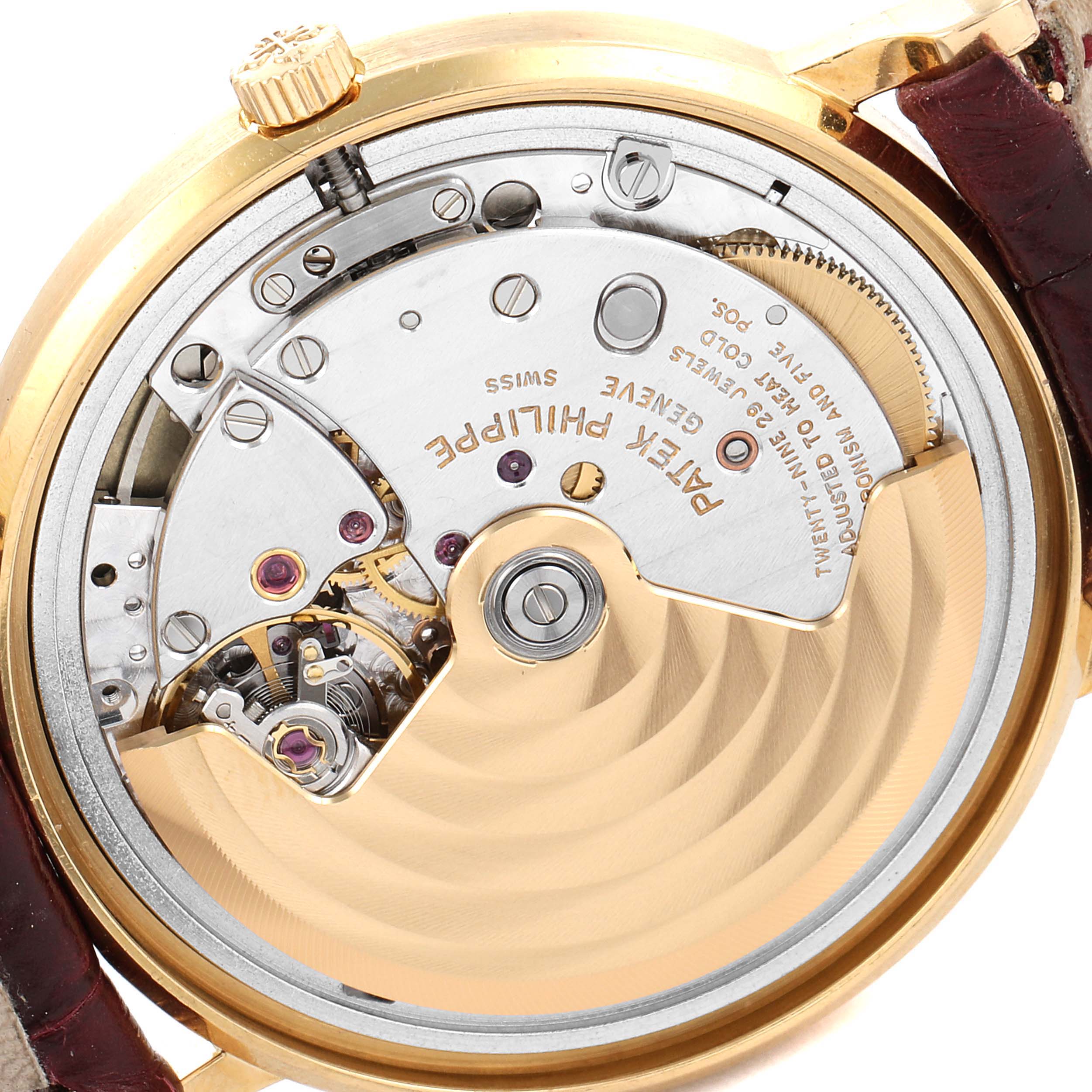 This is the back view of a Patek Philippe Calatrava 3802G Men's Yellow Gold White Dial 3802G Men's Yellow Gold White Dial watch, showing the intricate movement and mechanisms inside.