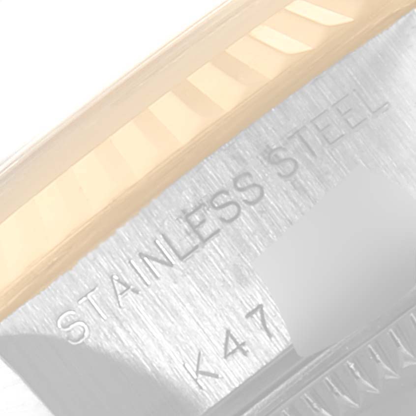 This image shows a close-up of the side of a Rolex Datejust 79173 Women's Stainless Steel Grey Dial 79173 Women's Stainless Steel Grey Dial model watch, highlighting the stainless steel material and part of the fluted bezel.