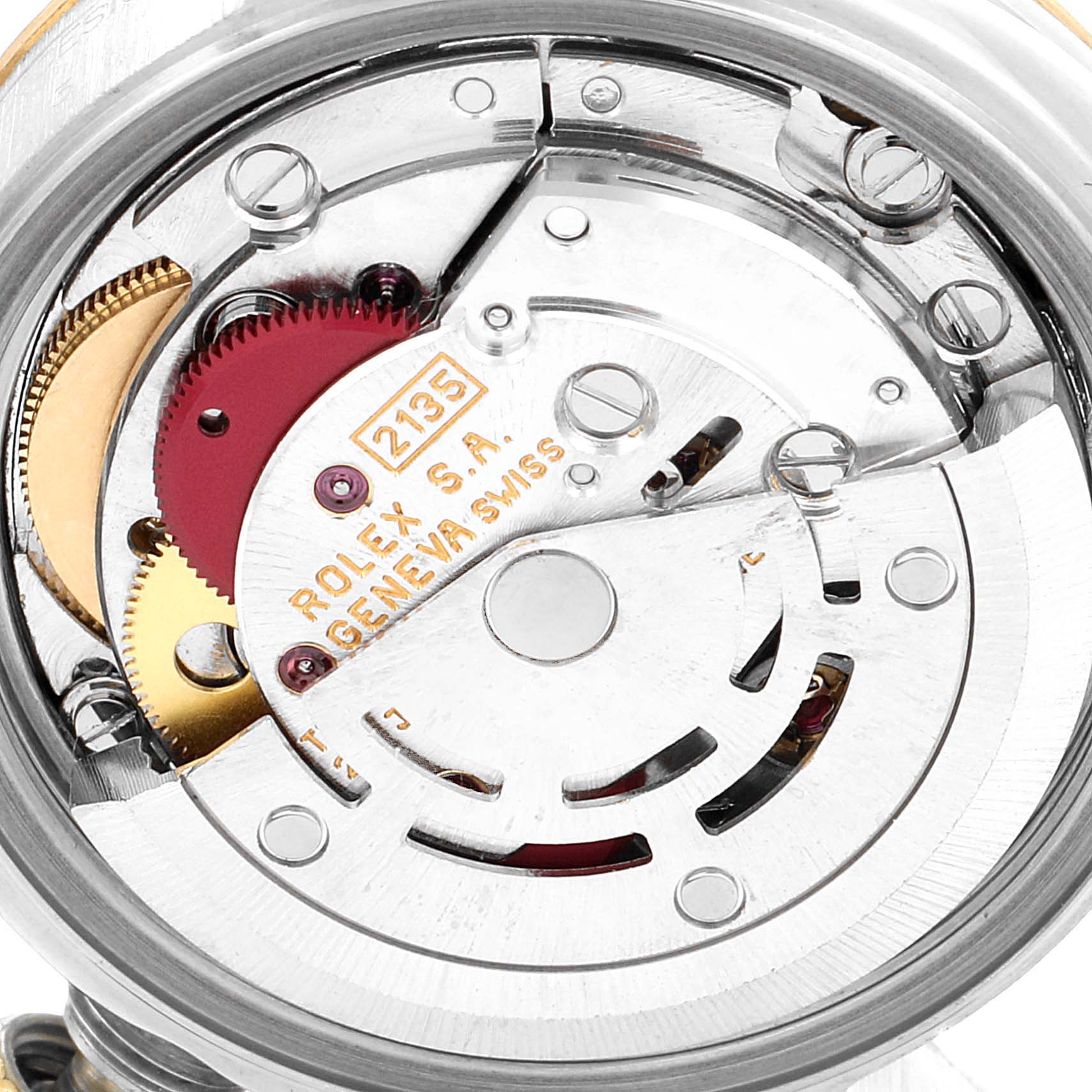 The image shows the inner mechanics of a Rolex Datejust 69173 Women's Steel and Gold (two tone) White Dial 69173 Women's Steel and Gold (two tone) White Dial watch, including gears and the movement mechanism.