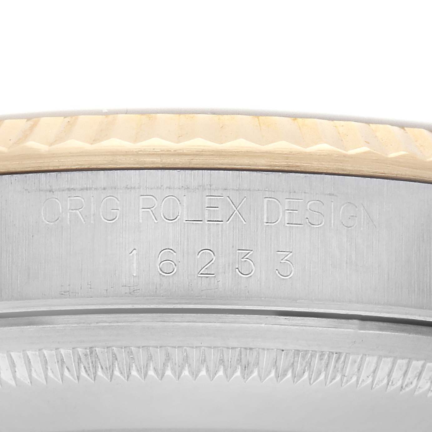 The image shows an angled view of the case side of a Rolex Datejust 16233 Men's Steel and Gold (two tone) Champagne Dial 16233 Men's Steel and Gold (two tone) Champagne Dial, highlighting the engraved design and model number.