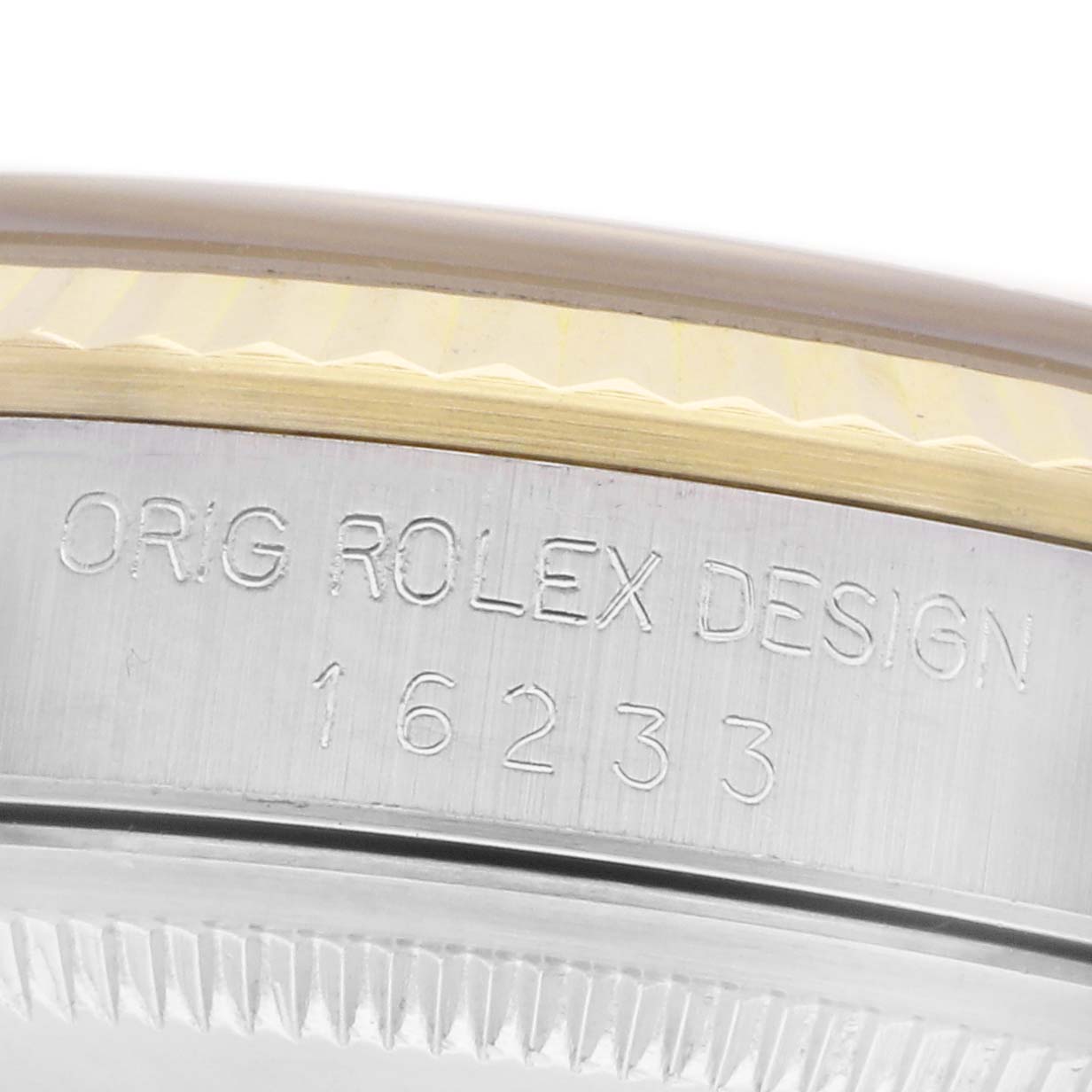 The image shows a close-up of the side of a Rolex Datejust 16233 Men's Steel and Gold (two tone) Champagne Dial 16233 Men's Steel and Gold (two tone) Champagne Dial, highlighting the engraved model number and part of the bezel.