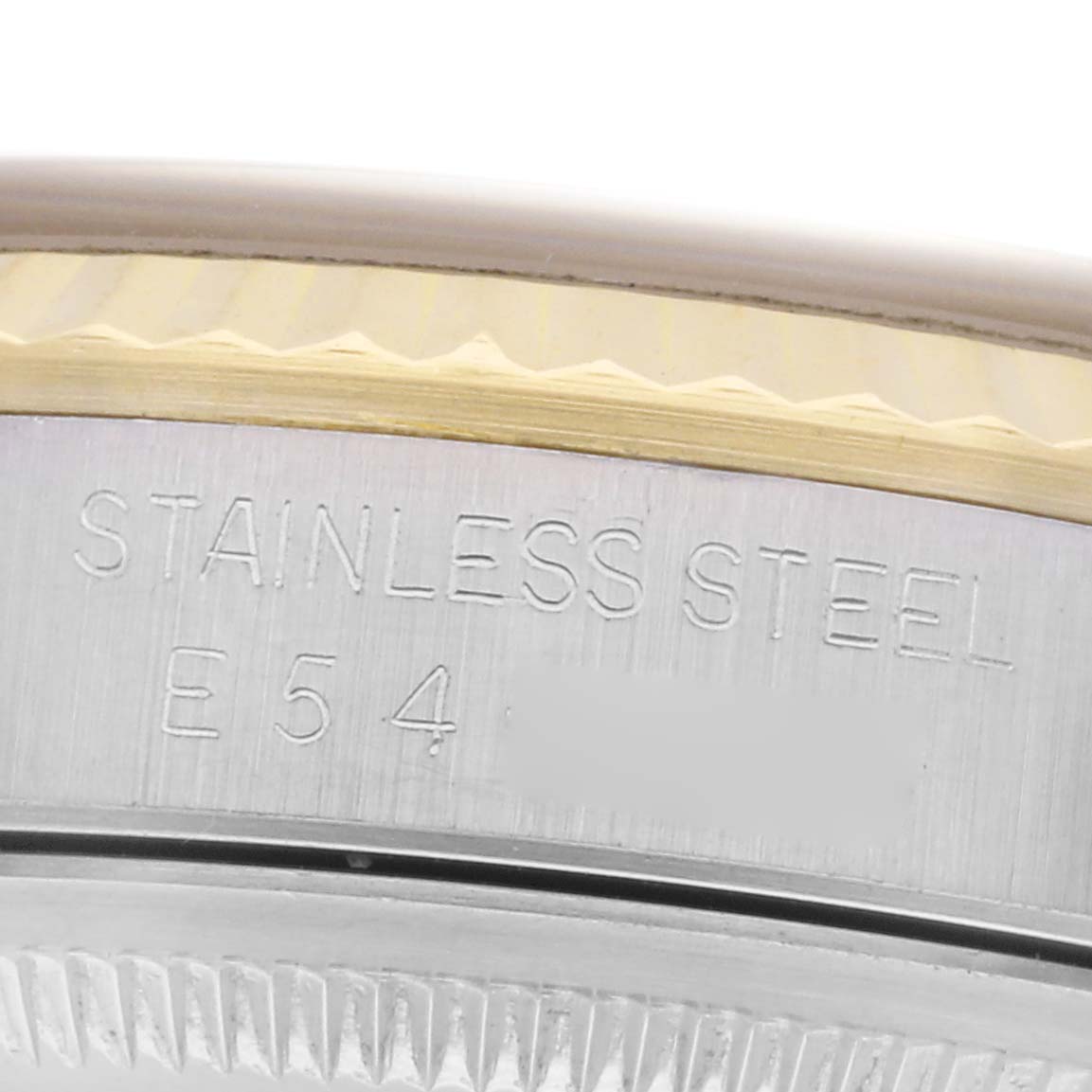 The image shows a close-up of the side of a Rolex Datejust 16233 Men's Steel and Gold (two tone) Champagne Dial 16233 Men's Steel and Gold (two tone) Champagne Dial watch, highlighting the stainless steel engraving on the case.