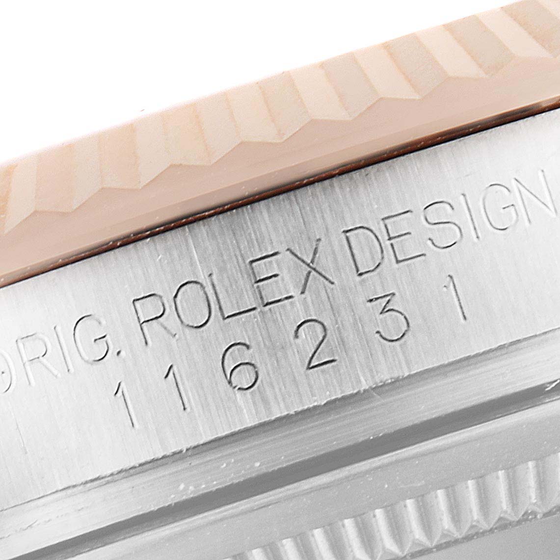 This image shows a close-up of the serial number engraving on the side of the Rolex Datejust 116231 Men's Steel and Gold (two tone) Pink Dial 116231 Men's Steel and Gold (two tone) Pink Dial watch case.