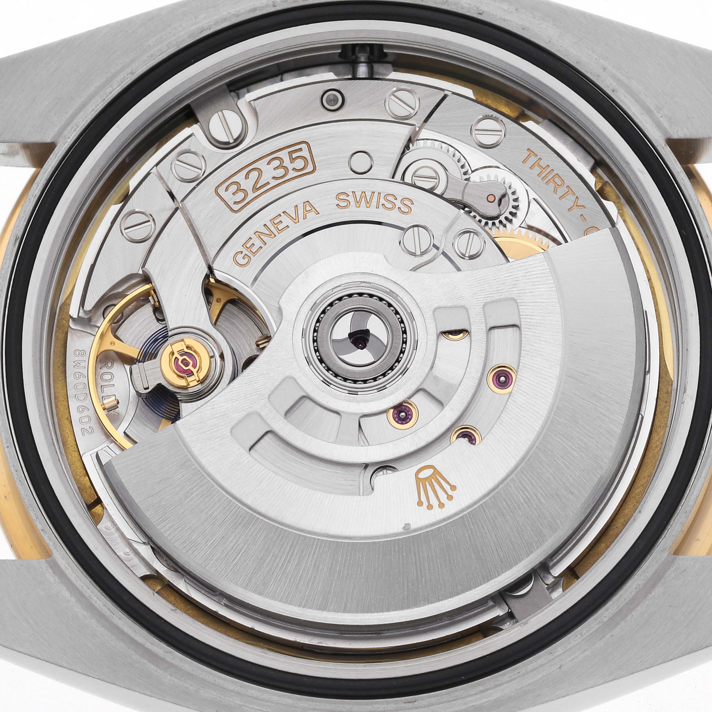 The image shows a close-up of the Rolex Datejust 41 126333 Men's Steel and Gold (two tone) White Dial 126333 Men's Steel and Gold (two tone) White Dial's movement from the back, highlighting the rotor and intricate mechanics.
