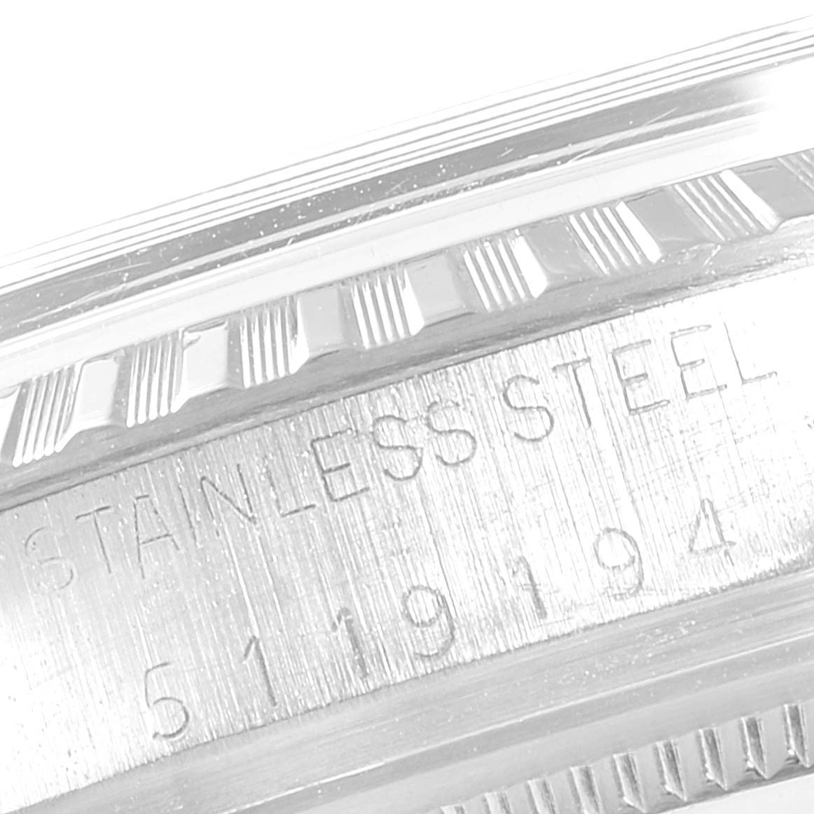 This close-up image of a Rolex Datejust 1603 Men's Stainless Steel Black Dial 1603 Men's Stainless Steel Black Dial watch displays the stainless steel case and part of the fluted bezel.