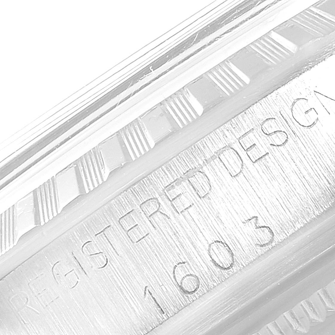This image shows a close-up of the engraved bezel and serial number area on a Rolex Datejust 1603 Men's Stainless Steel Black Dial 1603 Men's Stainless Steel Black Dial 1603 watch.