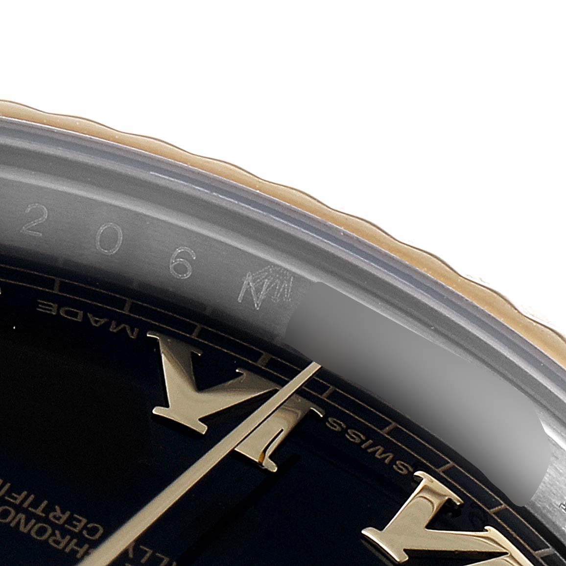 This close-up of a Rolex Datejust 41 116333 Men's Steel and Gold (two tone) Black Dial 116333 Men's Steel and Gold (two tone) Black Dial model shows the edge of the dial, bezel, and part of the Roman numeral markers.