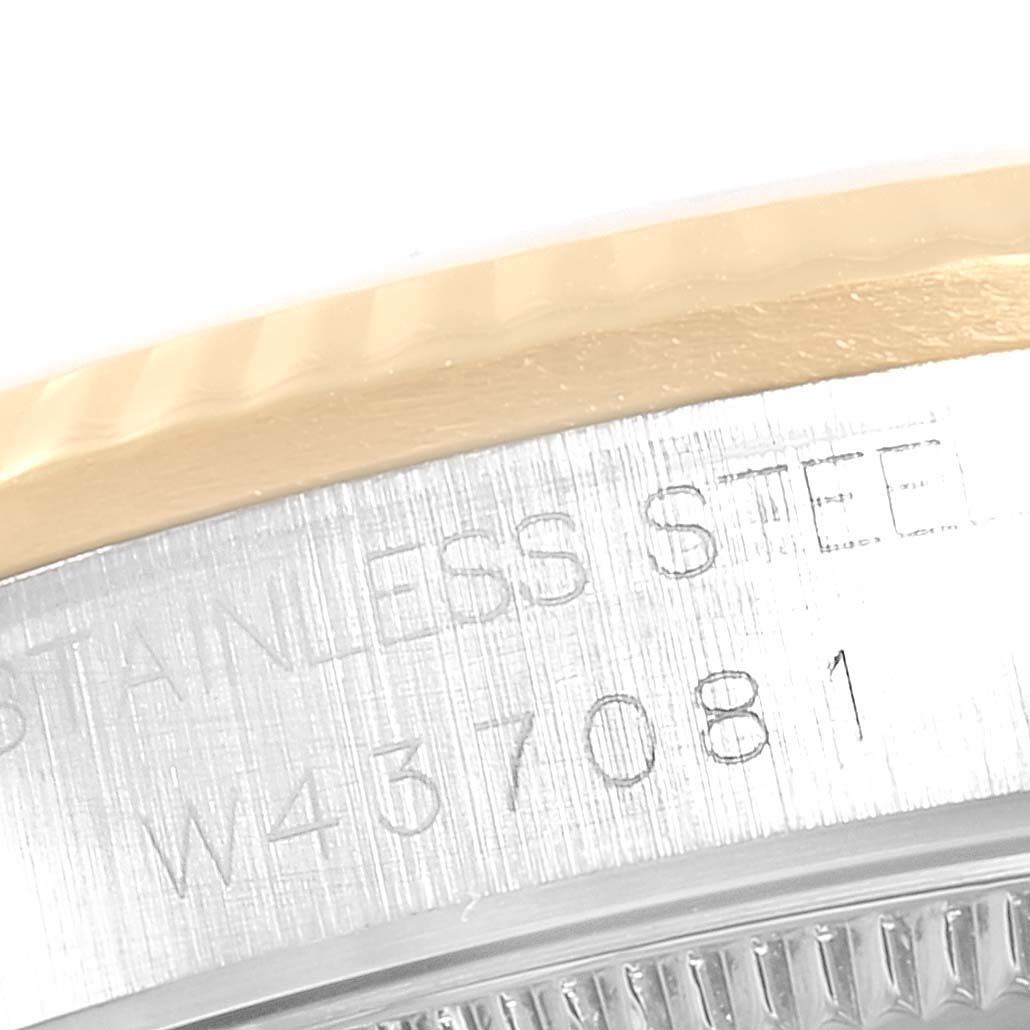 The image shows a close-up of the serial number and "STAINLESS STEEL" engraving on the case of a Rolex Mid-Size 68273 Women
s Steel and Gold (two tone) White Dial 68273 Women
s Steel and Gold (two tone) White Dial model watch.