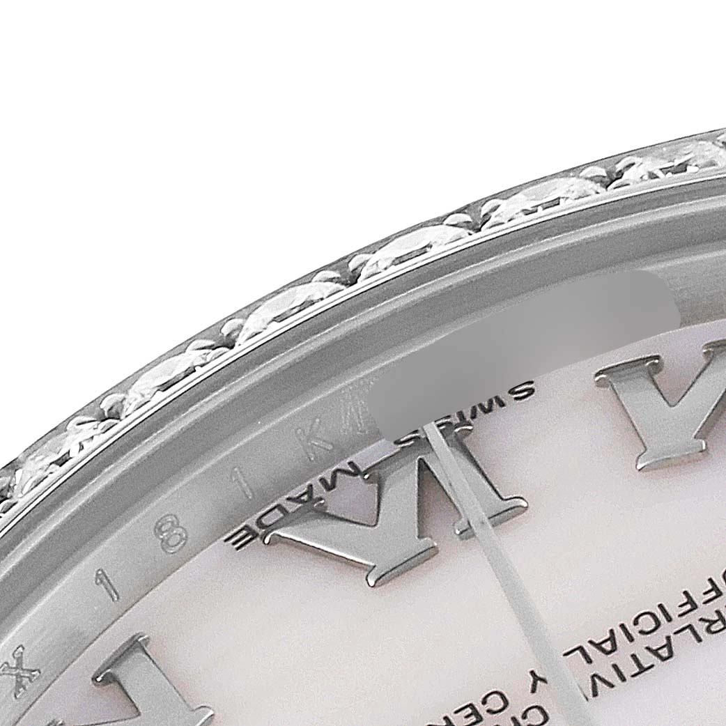 The image shows a close-up of the bezel and dial of a Rolex Mid-Size 178384 Women's Stainless Steel Mother of Pearl Dial 178384 Women's Stainless Steel Mother of Pearl Dial model, focusing on the Roman numeral markers and decorative details.