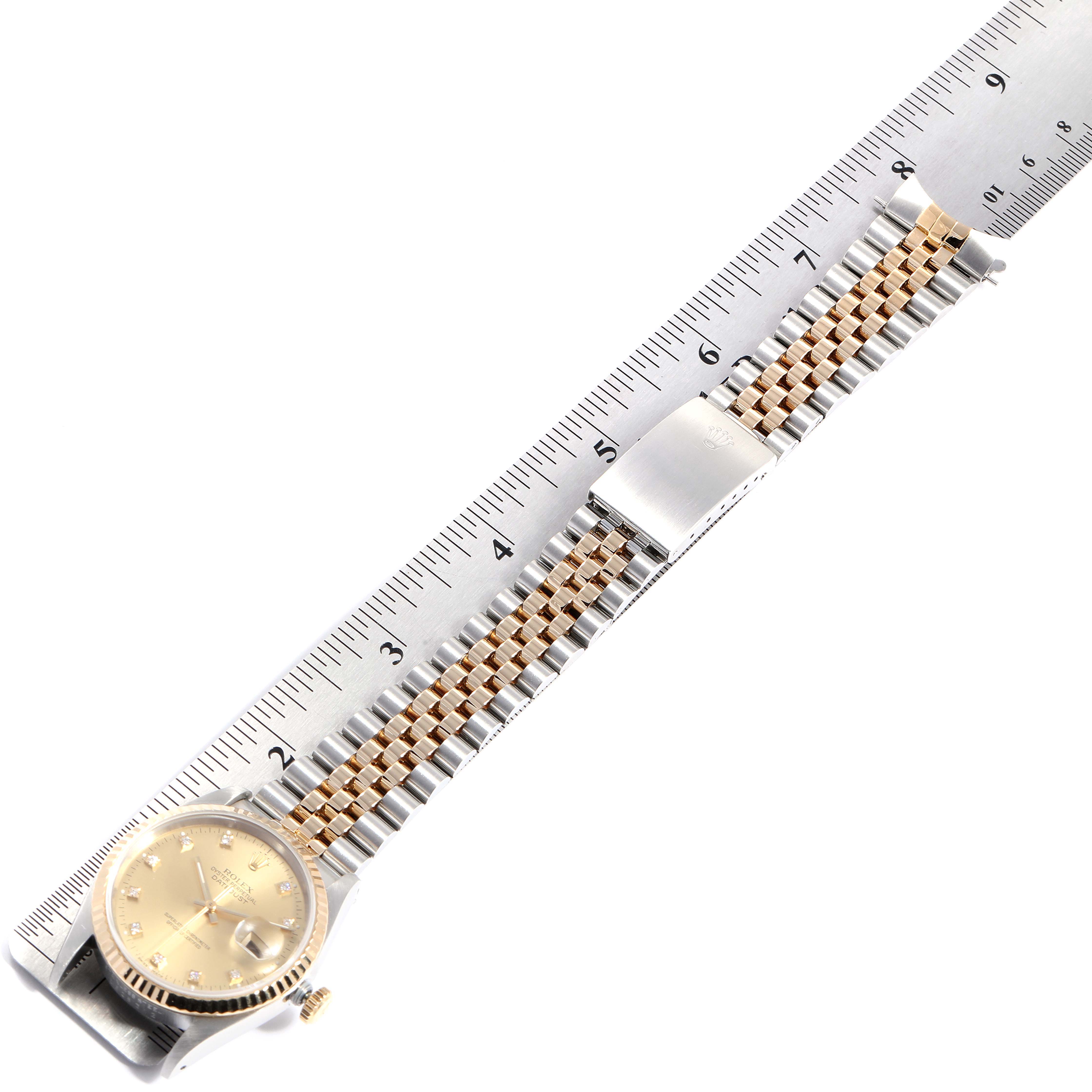 The image shows a Rolex Datejust 16233 Men
s Steel and Gold (two tone) Champagne Dial 16233 Men
s Steel and Gold (two tone) Champagne Dial watch from a top-down angle alongside a measurement ruler, highlighting the dial and bracelet.