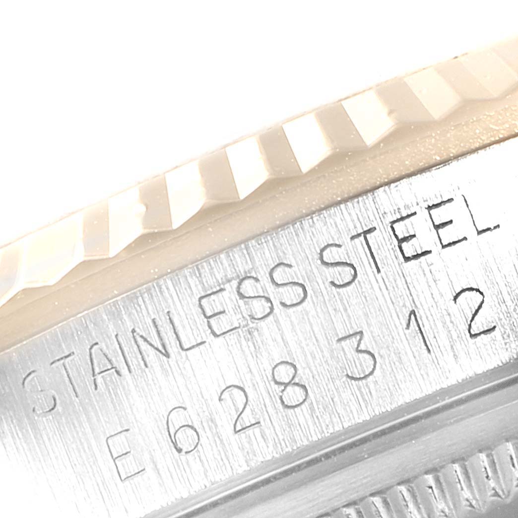 The image shows a close-up view of the serial number and "STAINLESS STEEL" engraving on a Rolex Datejust 16233 Men
s Steel and Gold (two tone) Champagne Dial 16233 Men
s Steel and Gold (two tone) Champagne Dial watch bezel.