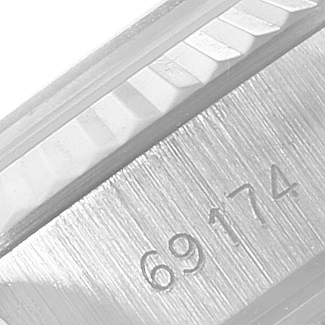 This close-up image shows the engraved reference number and fluted bezel of a Rolex Datejust 69174 Women
s Stainless Steel Silver Dial 69174 Women
s Stainless Steel Silver Dial watch.