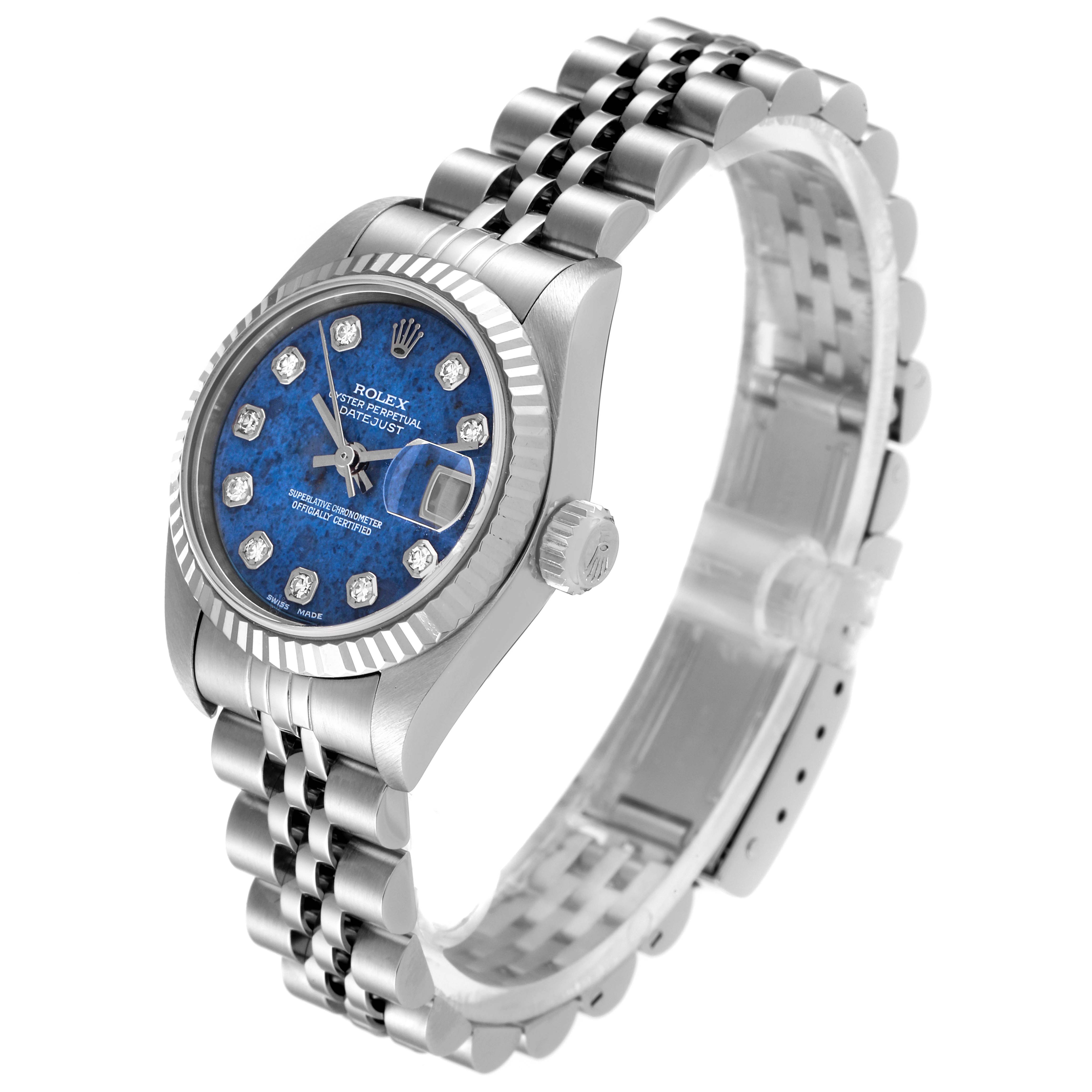 The image shows a Rolex Datejust 79174 Women's Stainless Steel Blue Dial 79174 Women's Stainless Steel Blue Dial watch with a blue dial, diamond hour markers, and a jubilee bracelet at an angled side view.