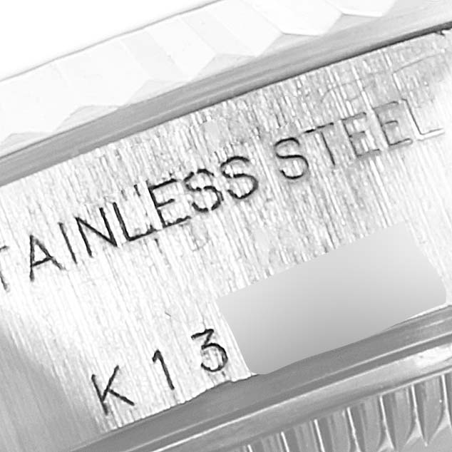 The image shows a close-up of the stainless steel bezel and engraving on a Rolex Datejust 79174 Women's Stainless Steel Blue Dial 79174 Women's Stainless Steel Blue Dial watch.