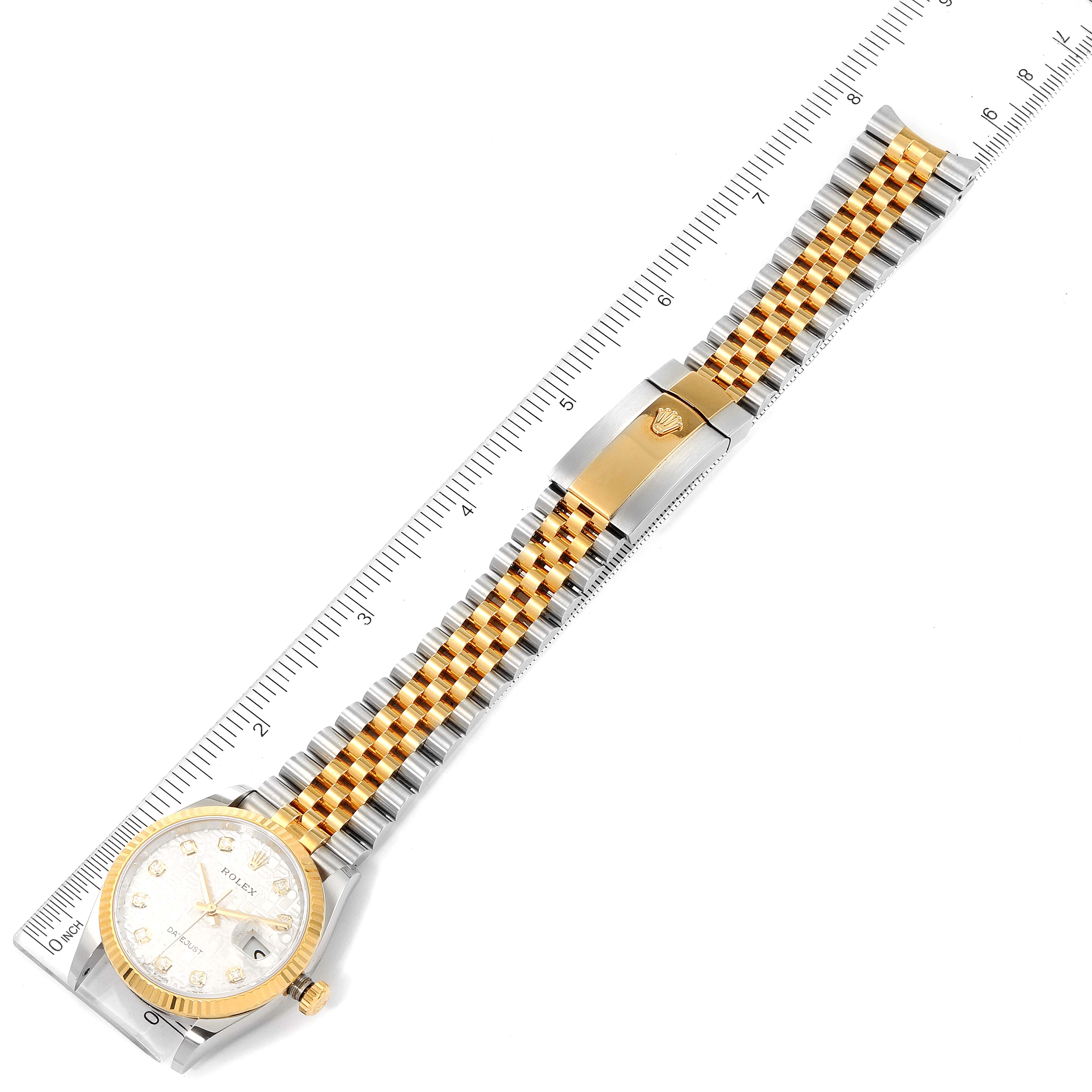 The image shows a Rolex Datejust 126233 Men's Steel and Gold (two tone) Silver Dial 126233 Men's Steel and Gold (two tone) Silver Dial watch laid flat from a top-down angle, including the face, bracelet, and clasp alongside a ruler.