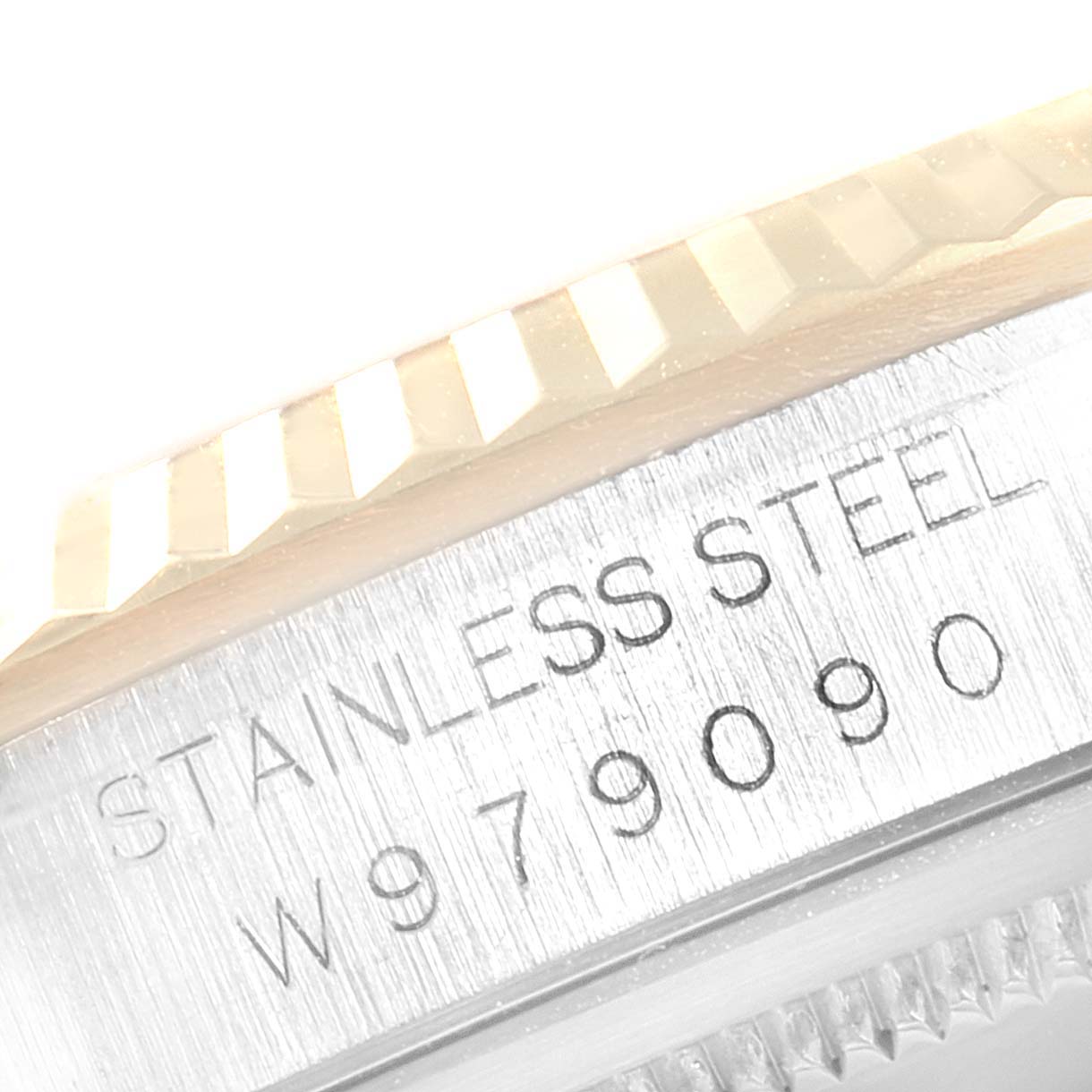 The image shows a close-up of the Rolex Datejust 16233 Men
s Steel and Gold (two tone) Mother of Pearl Dial 16233 Men
s Steel and Gold (two tone) Mother of Pearl Dial model
s stainless steel case with a fluted bezel and its serial number.