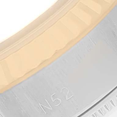 The image shows a close-up of the bezel and part of the case of a Rolex Datejust 69173 Women
s Steel and Gold (two tone) White Dial 69173 Women
s Steel and Gold (two tone) White Dial watch.